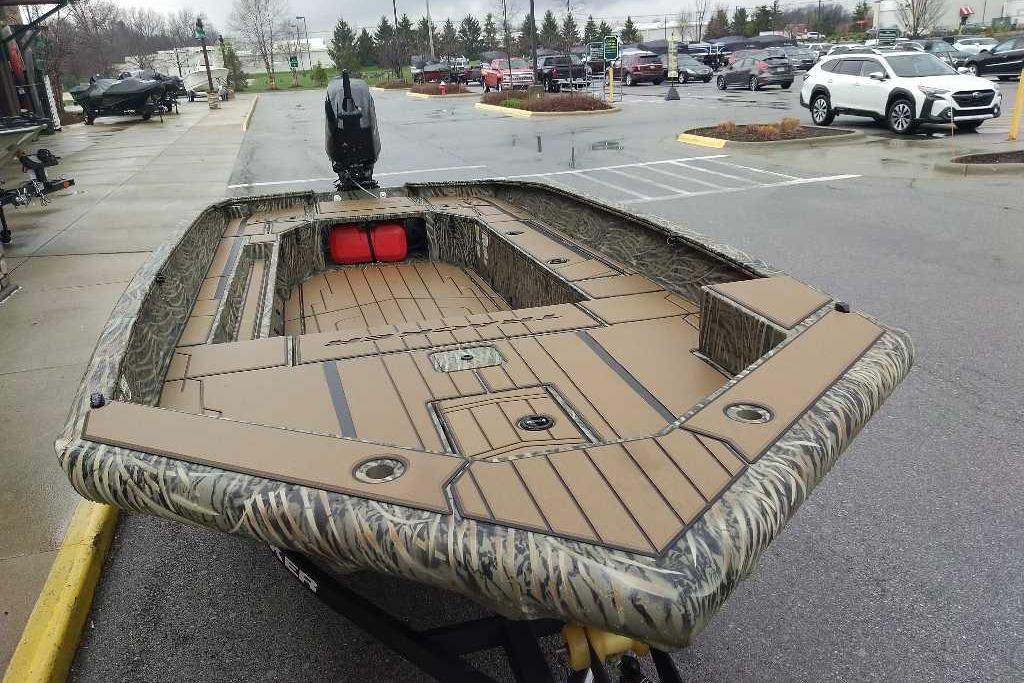 2026 Tracker Grizzly 1756 T Marsh boat with camouflage design in a parking lot.