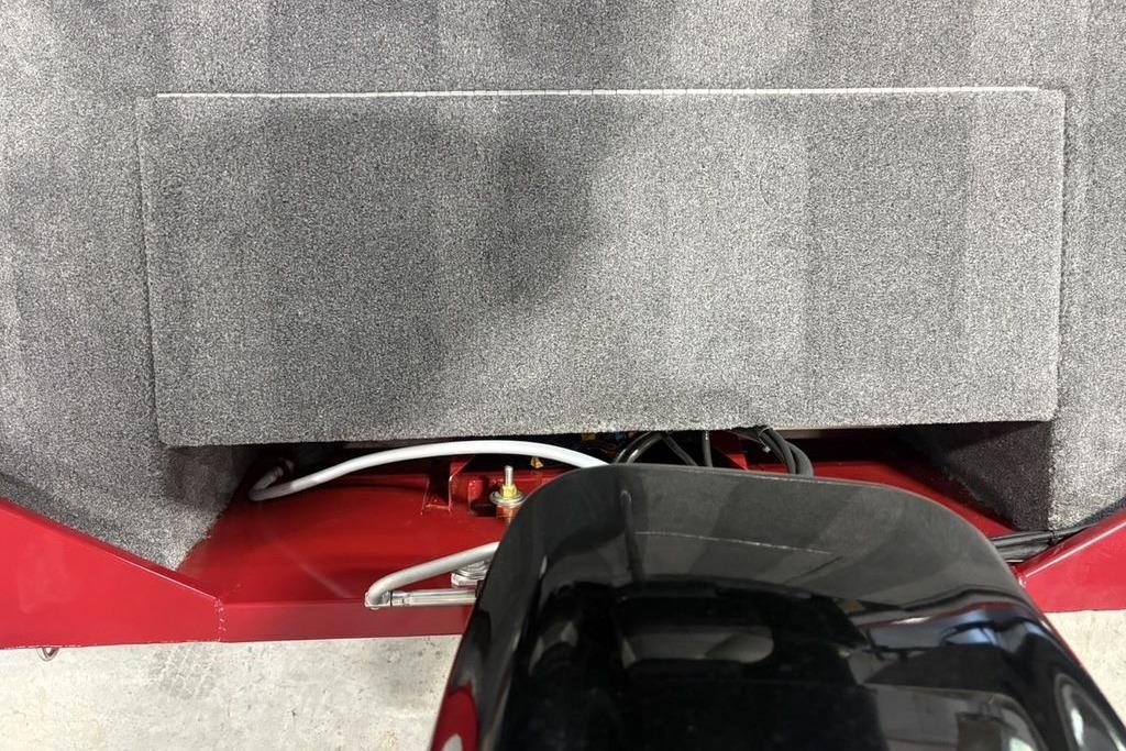 Interior view of a 2026 Tracker Bass Tracker Classic XL boat, showcasing wiring and carpeted surfaces.