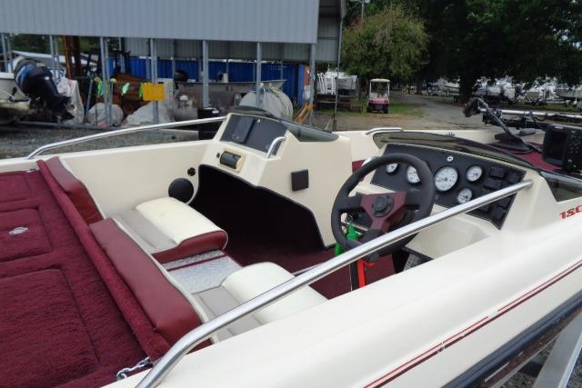 1996 Quantum 180 XD boat interior with maroon seating and dashboard controls.