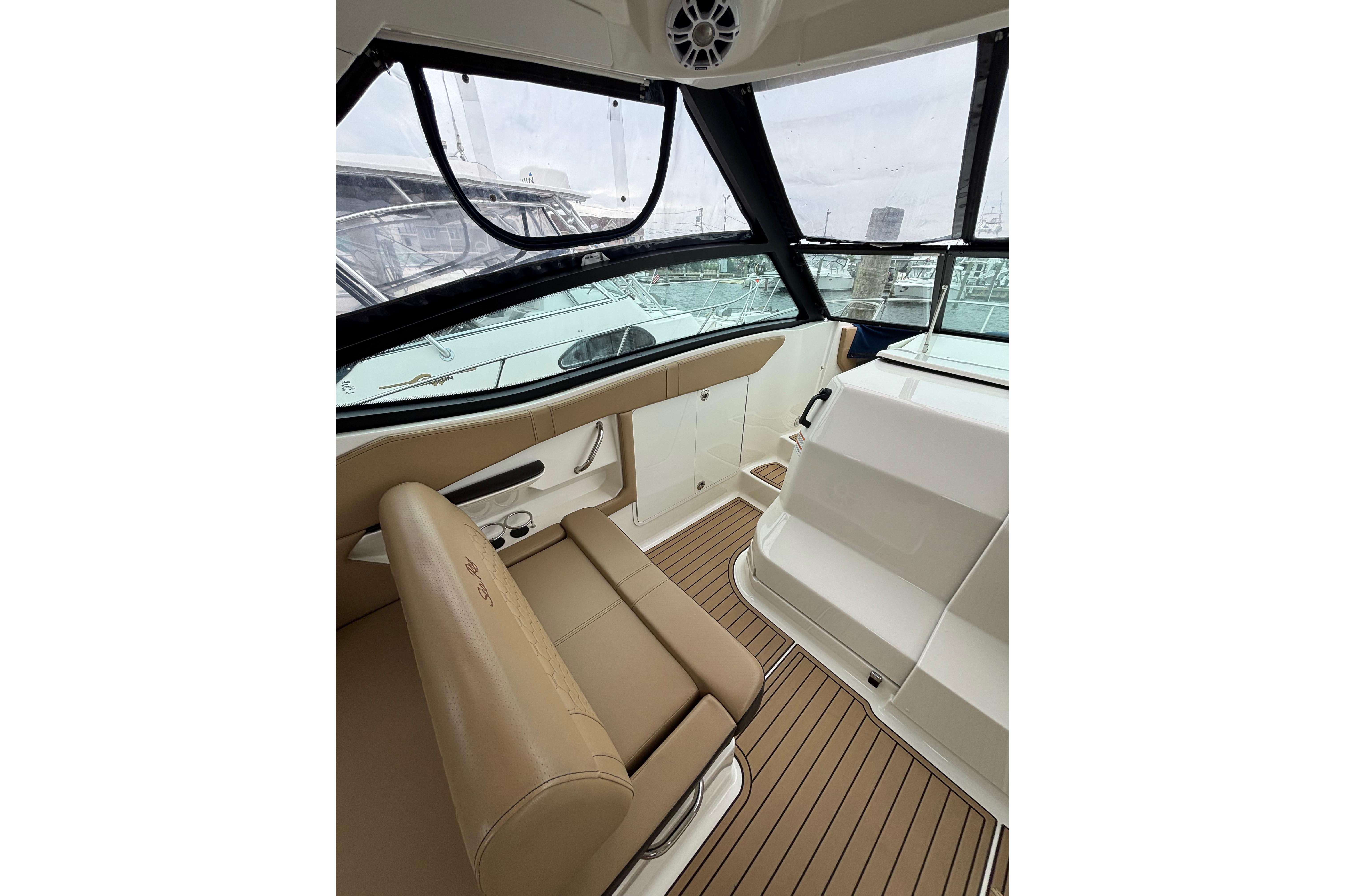 Interior view of 2021 Sea Ray Sundancer 320 Outboard, featuring tan seating and sleek design.