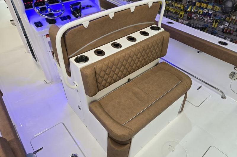 2026 Sea Hunt Ultra 275 Coffin Box boat interior with brown seating and cup holders.