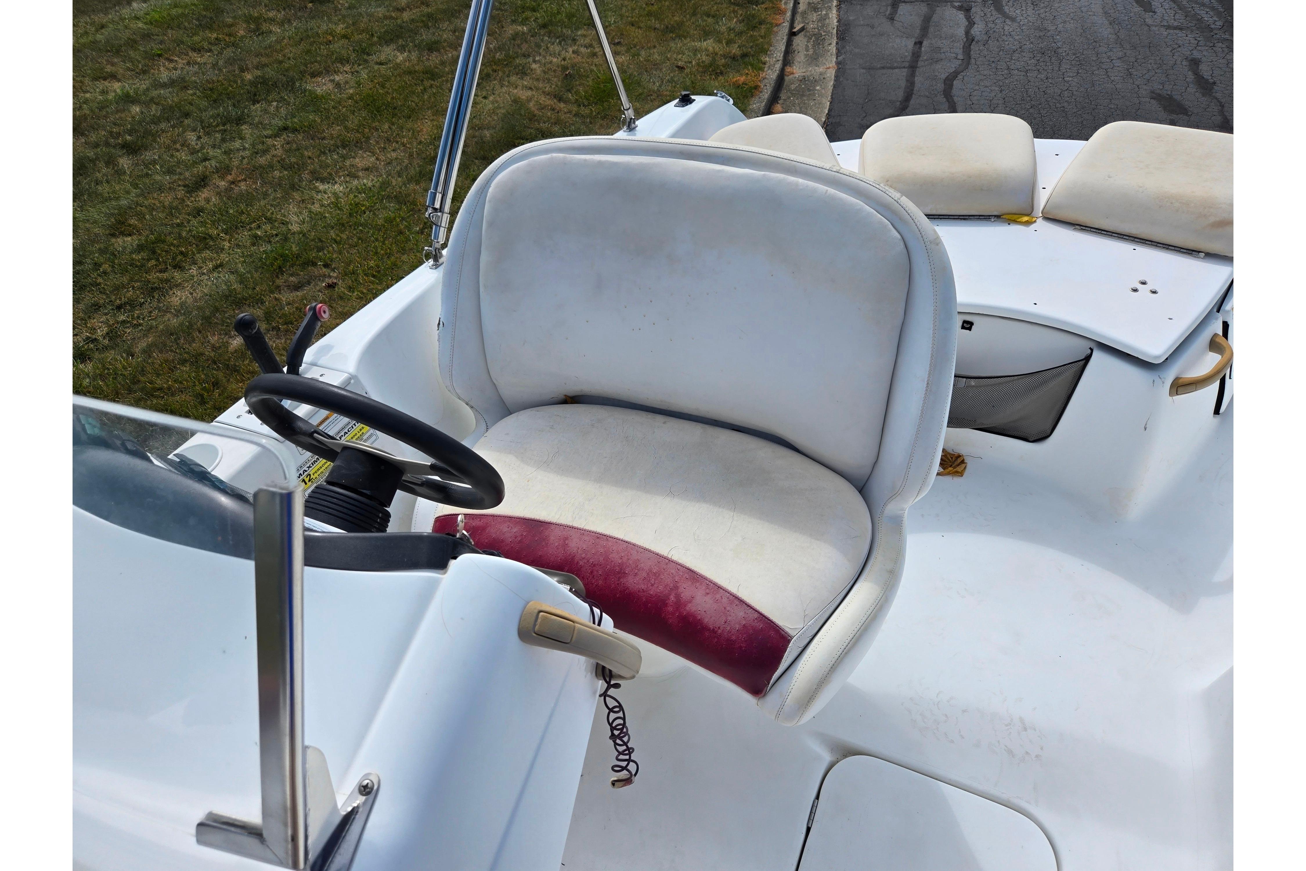 2004 Sea-Doo Islandia boat cockpit with steering wheel and cushioned seat.