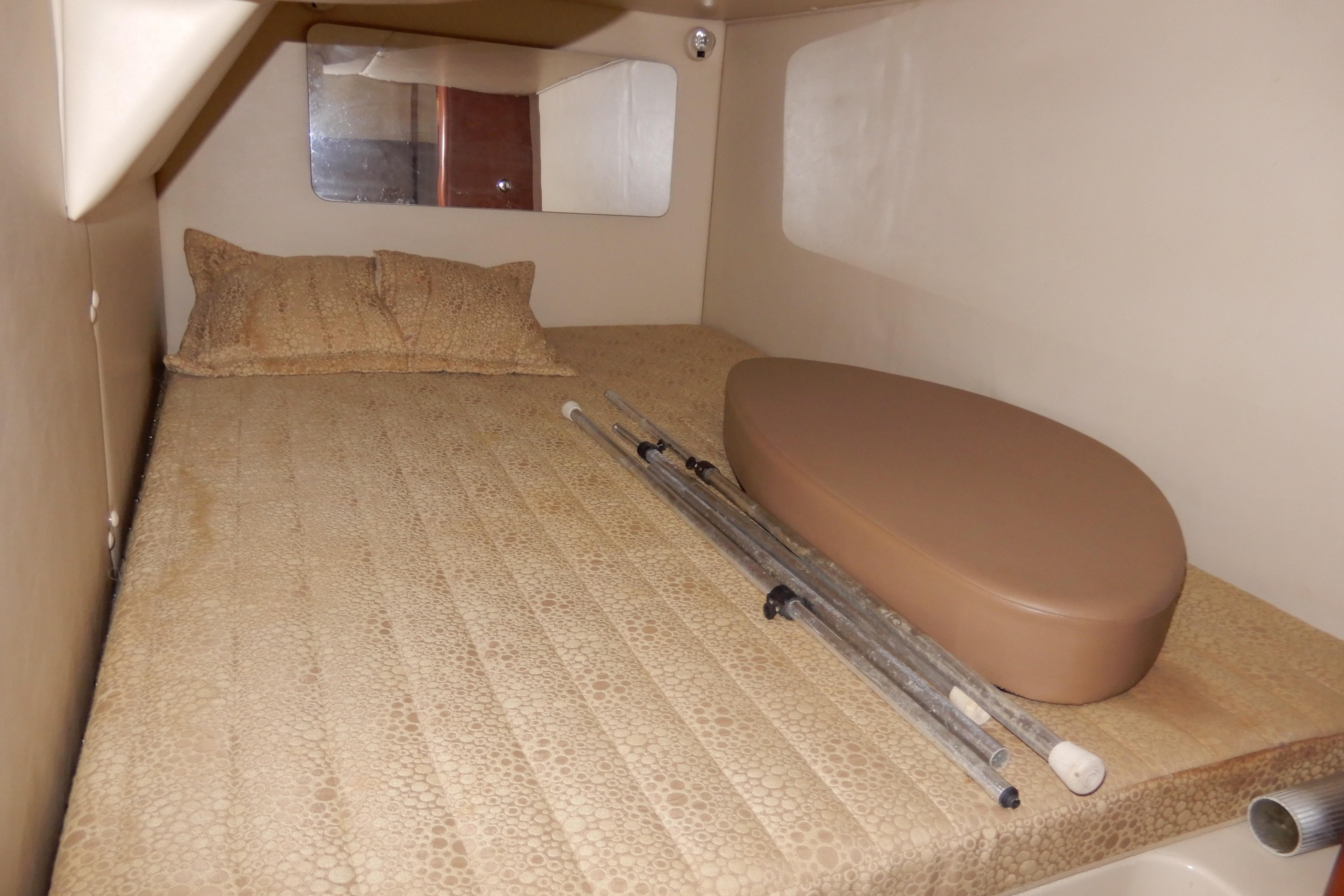 2002 Chaparral Signature 320 cabin interior with bed and accessories.