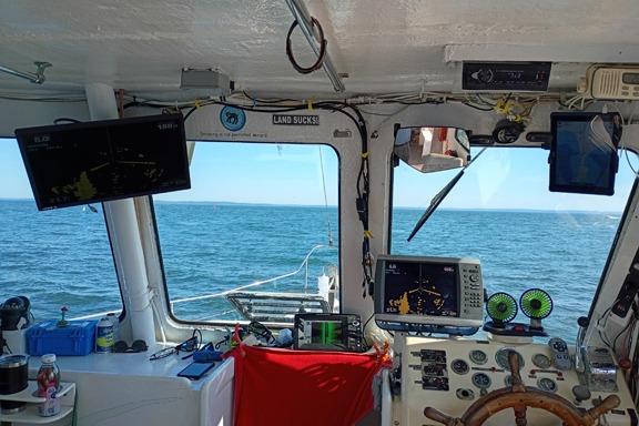 Cockpit view of 1980 Thompson Passenger and Dive Trawler with navigation equipment and ocean scenery.
