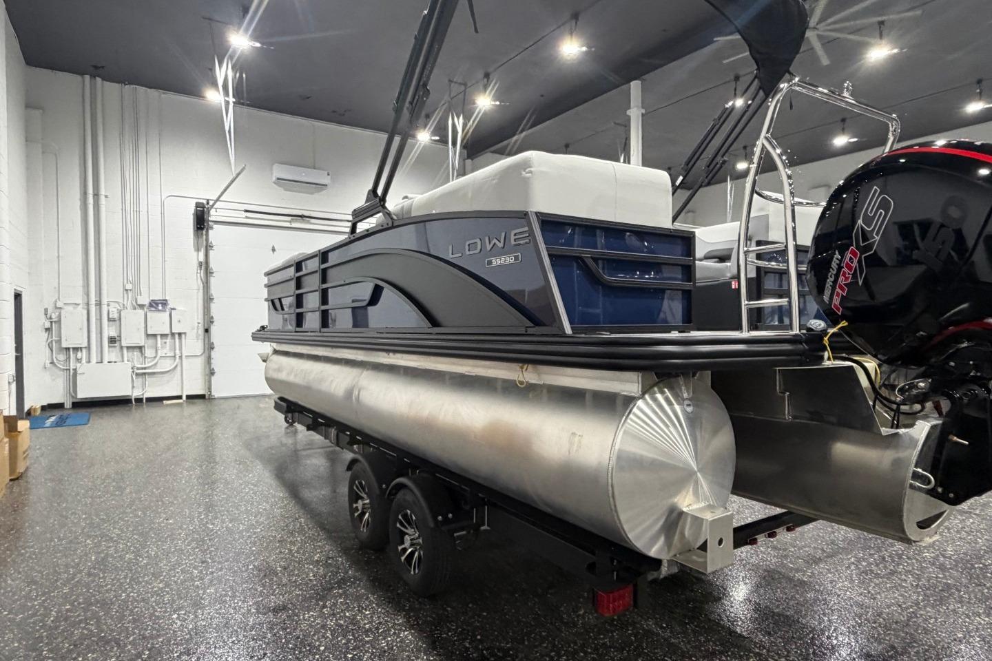 2026 Lowe SS 230 WT pontoon boat in a showroom, featuring sleek design and powerful engine.