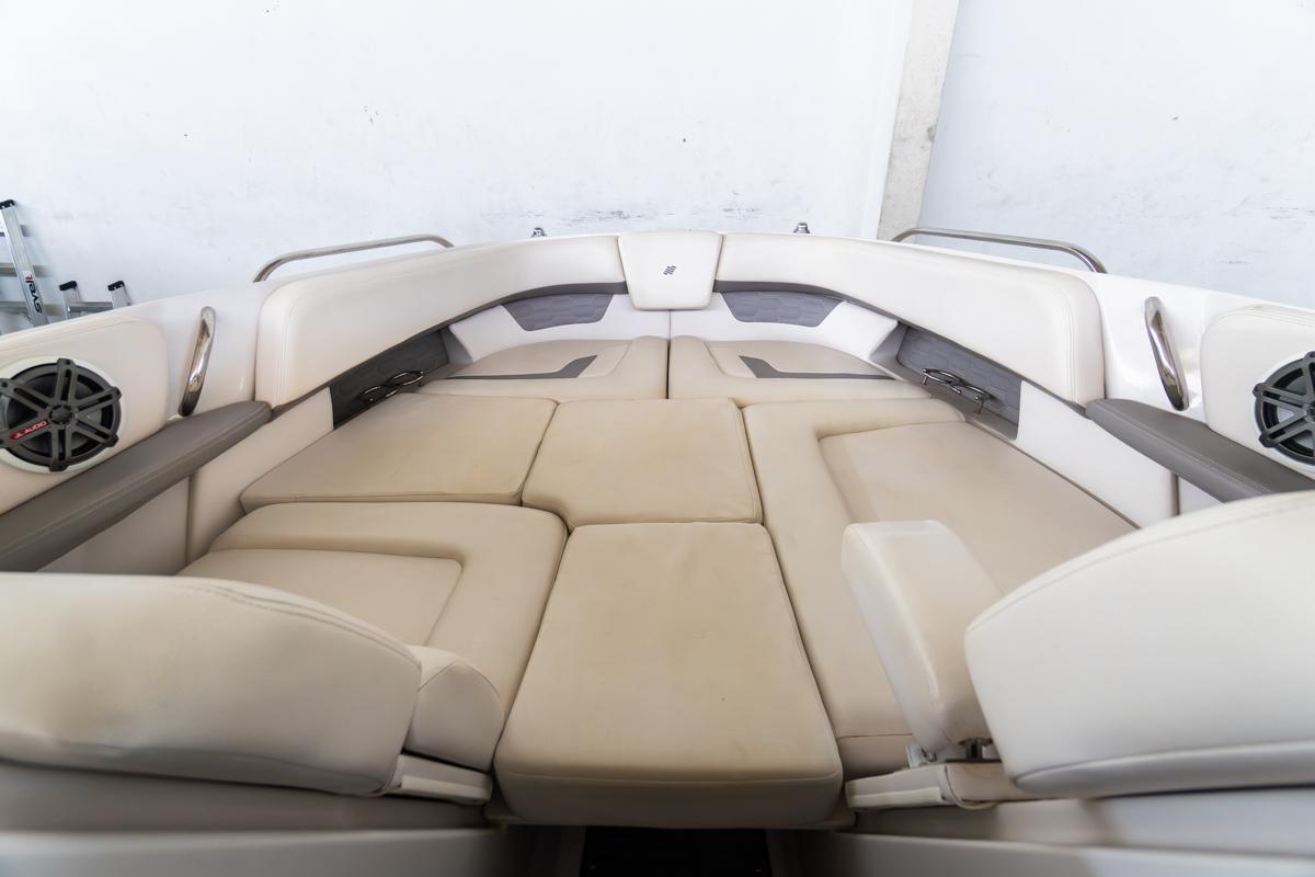 2018 Four Winns 290 Horizon boat interior with beige seating and built-in speakers.