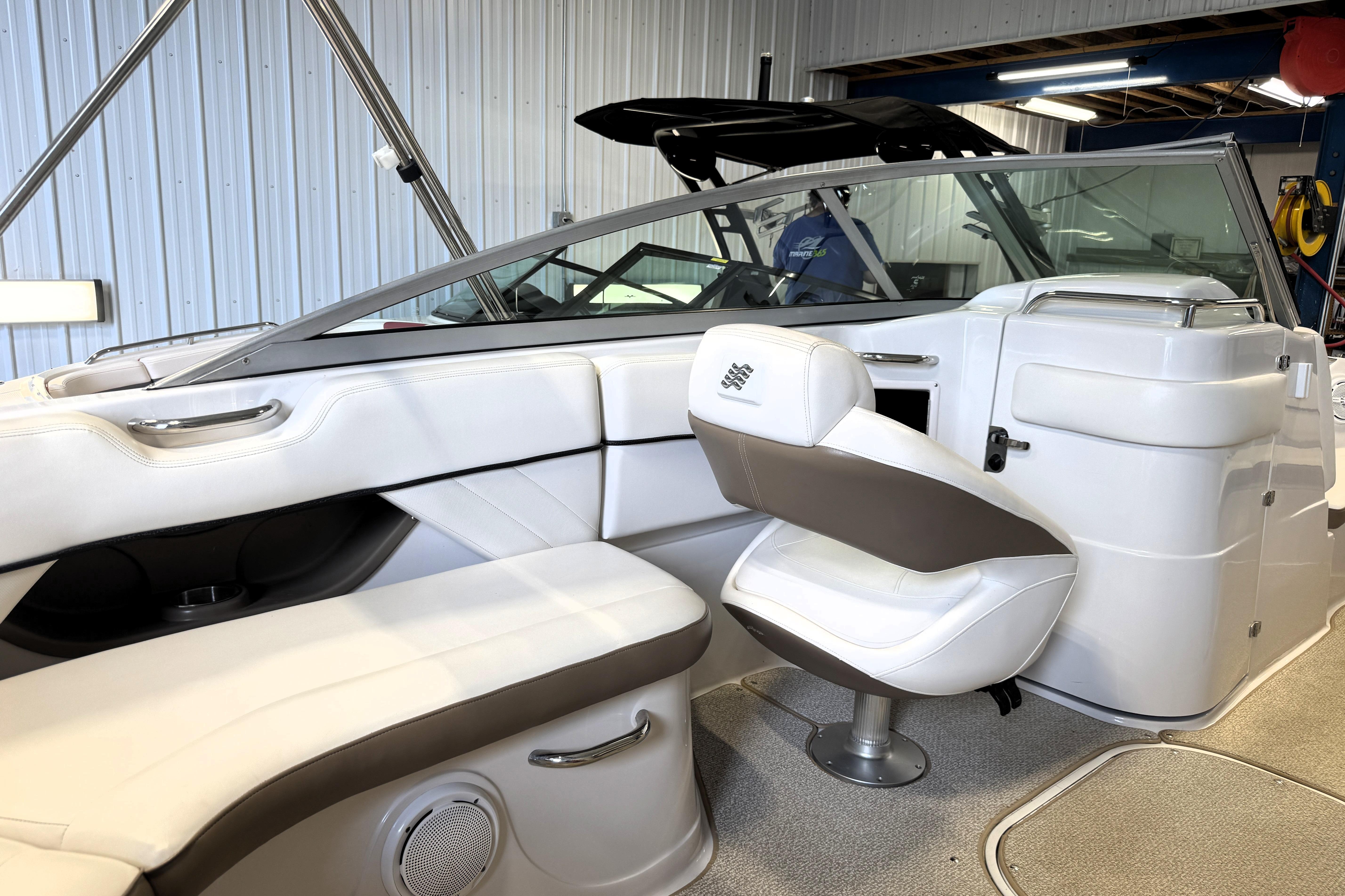 Interior of a 2008 Four Winns H240 boat with white and gray seating.