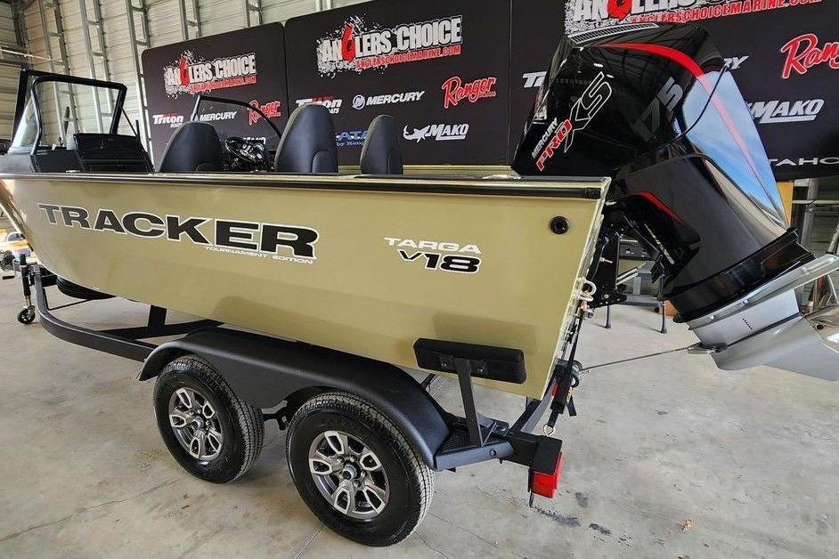 2026 Tracker Targa 185 WT boat on trailer, displayed indoors with promotional banners.