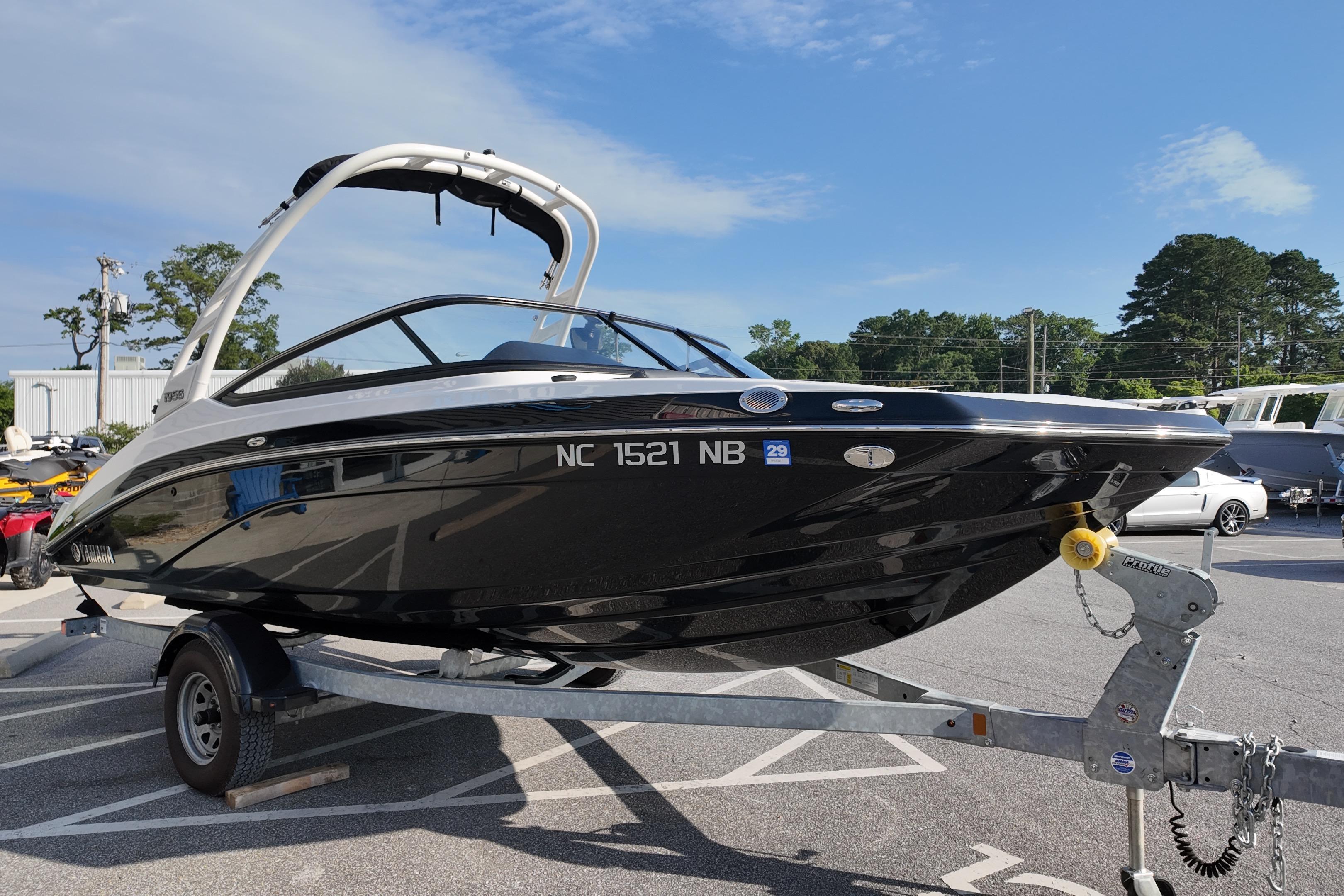 2023 Yamaha 195S boat on trailer in parking lot, sunny day.