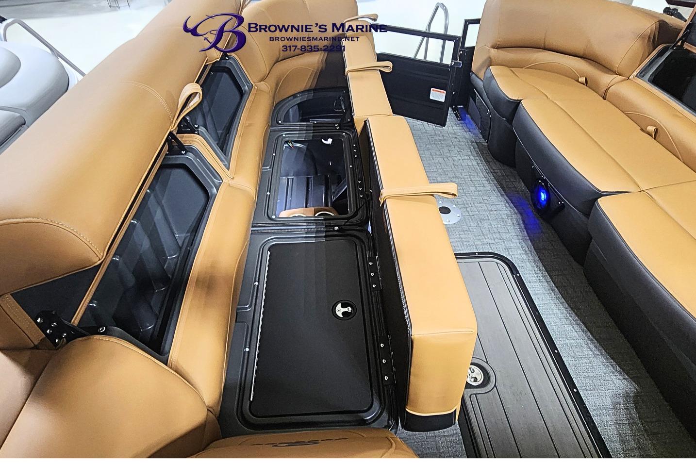 Luxurious interior of 2026 Regency 250 DL boat with tan seating and storage compartments.