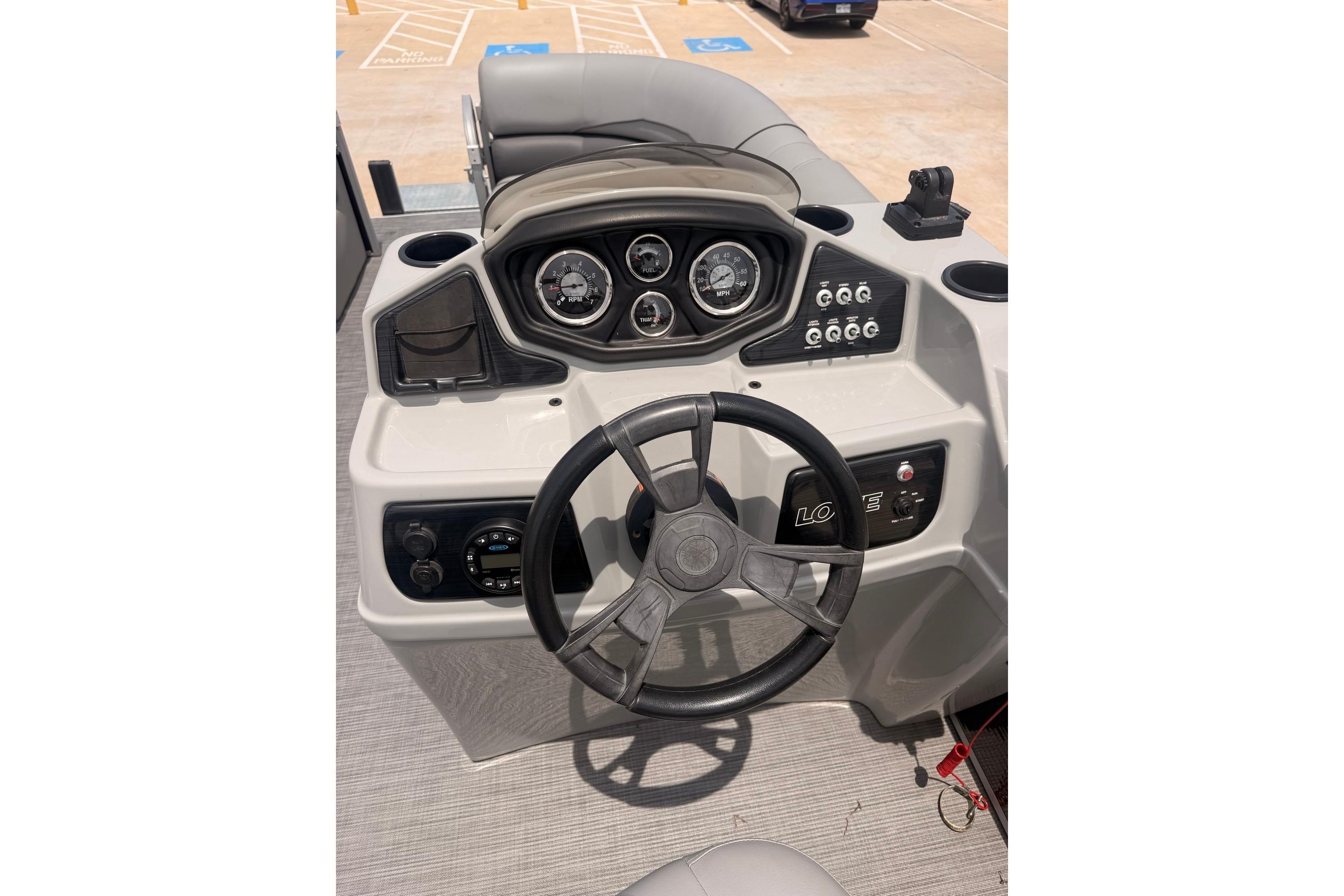 Steering console of a 2021 Lowe SS 210 boat with gauges and controls.
