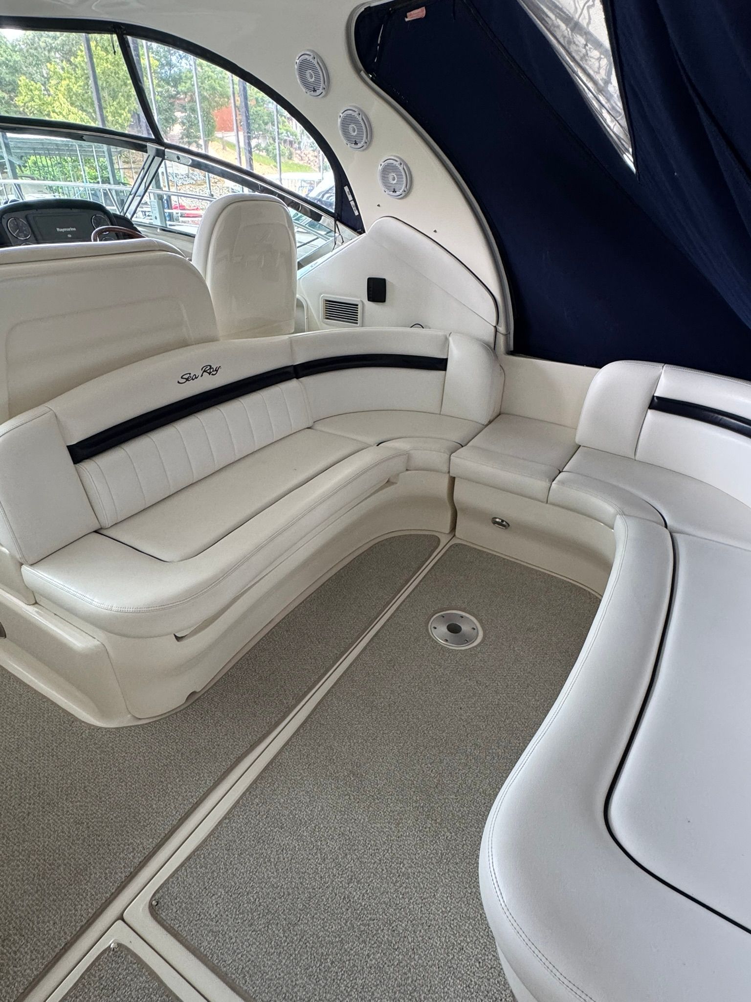 Interior of the 2007 Sea Ray 40 Sundancer with white leather seating and carpeted floor.