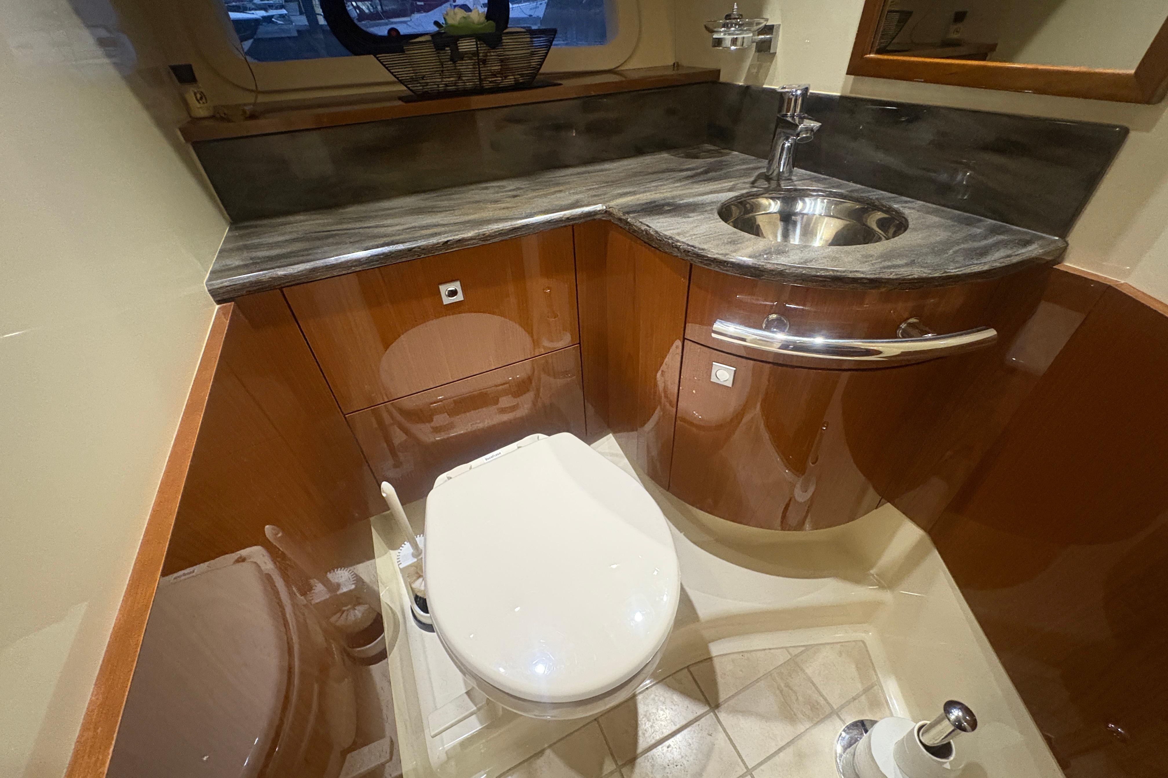 Luxurious bathroom in 2015 Sea Ray 470 Sundancer yacht with modern fixtures.