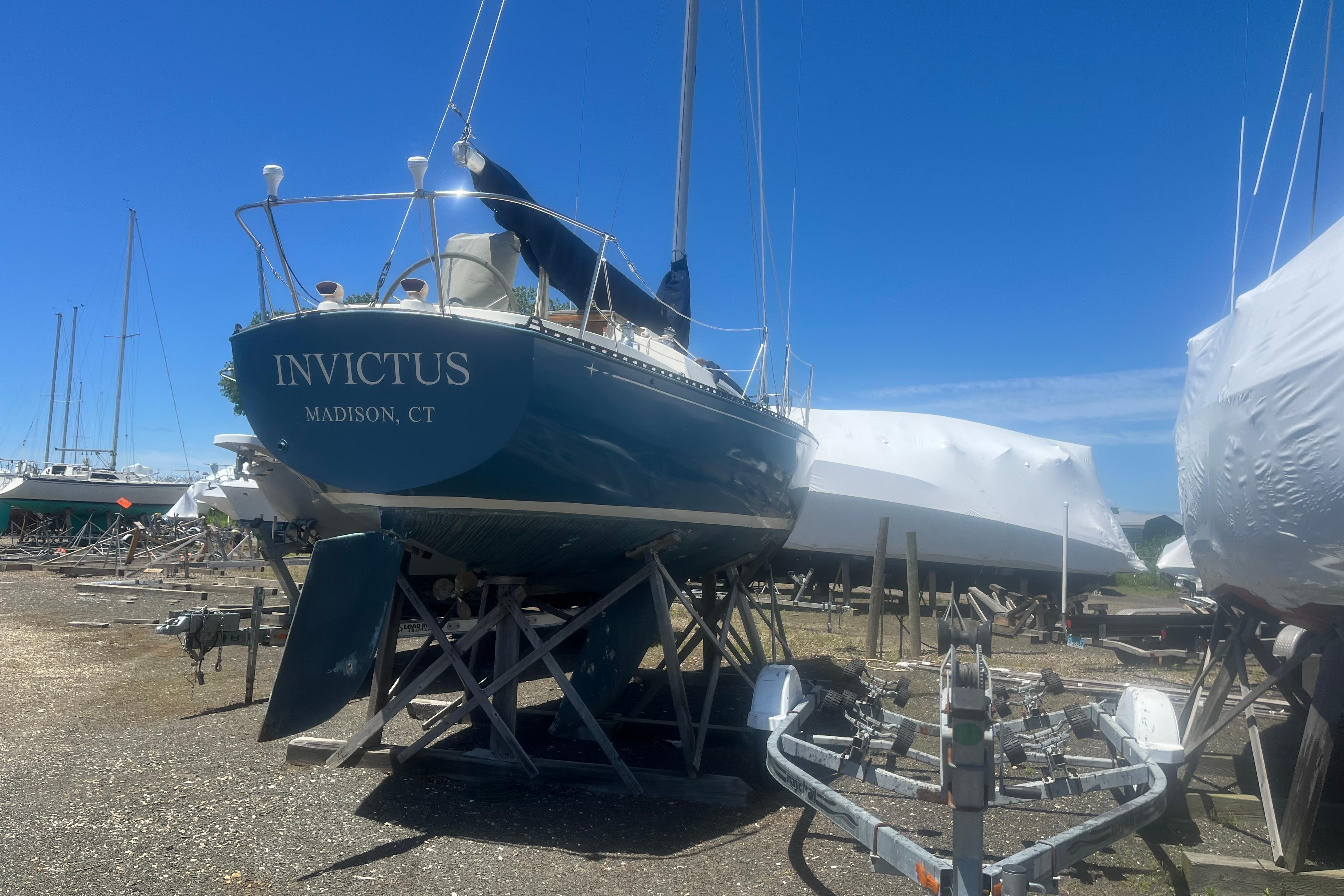 Sailboat "Invictus" on stands, C&C 30 model, 1972, Madison, CT, in a boatyard.