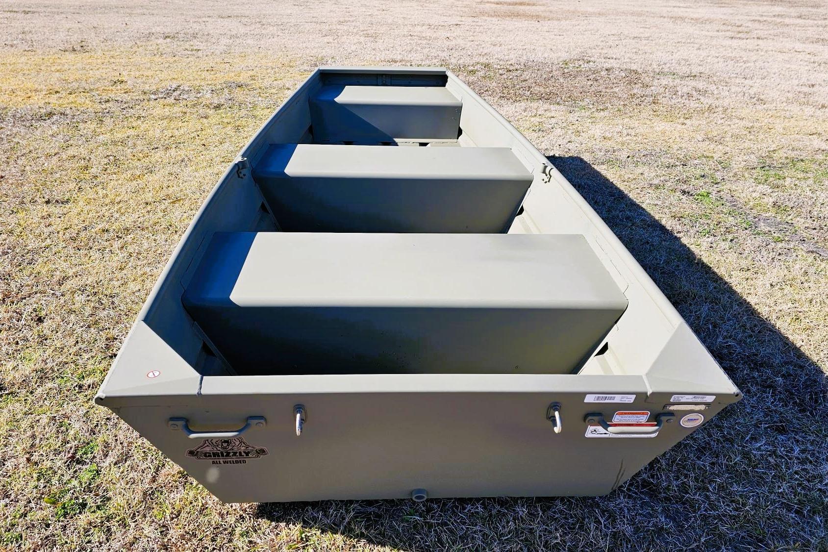 2026 Tracker Grizzly 10 Jon boat on grass, showcasing sturdy design and seating.