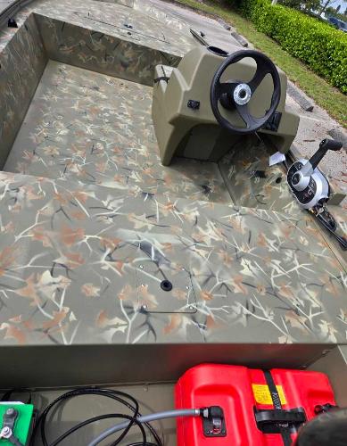 2025 Tracker Grizzly 1648 SC boat with camouflage interior and steering console.