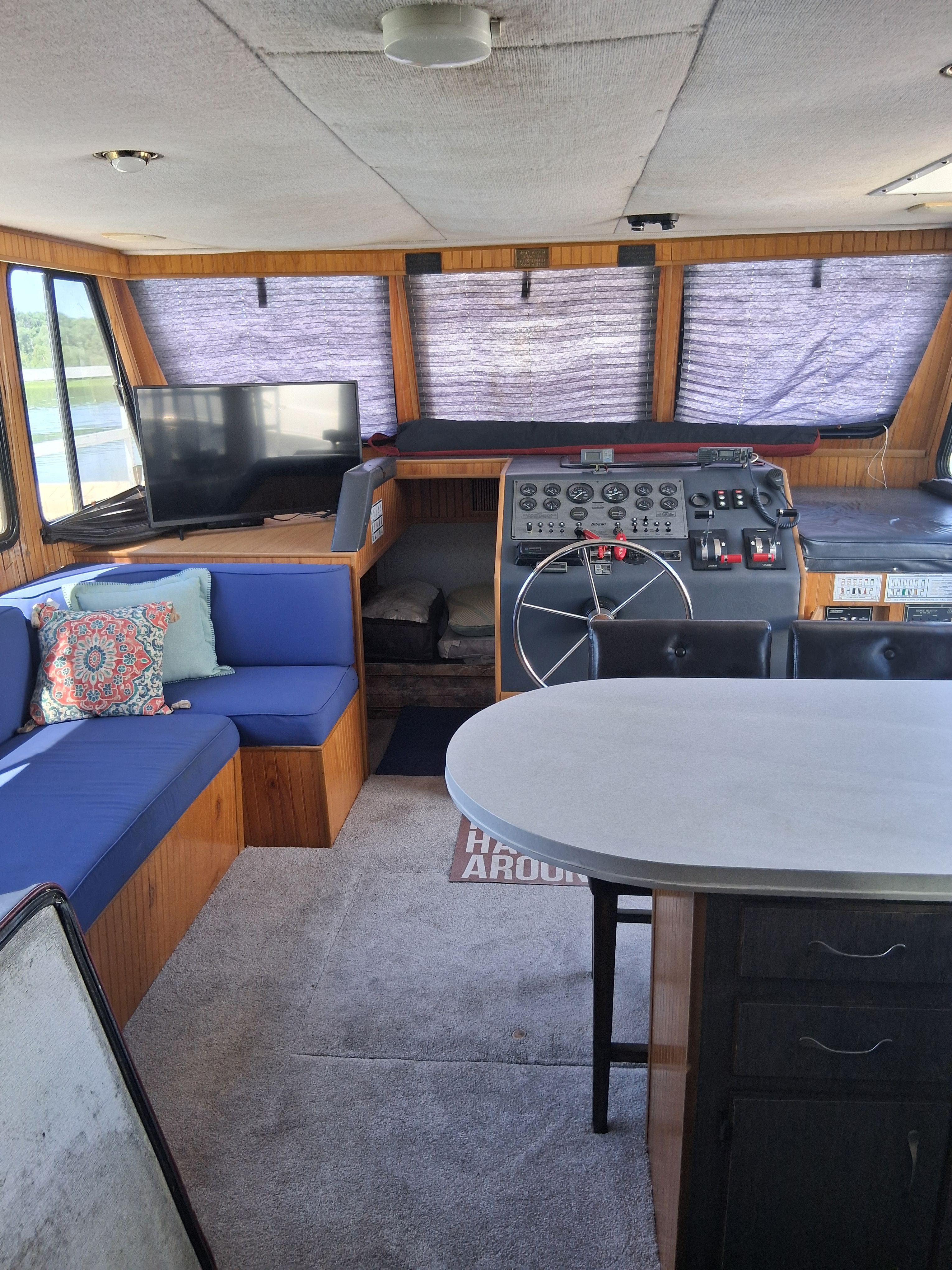 Interior of a 1993 Gibson 370 Sport with blue seating and a helm station.