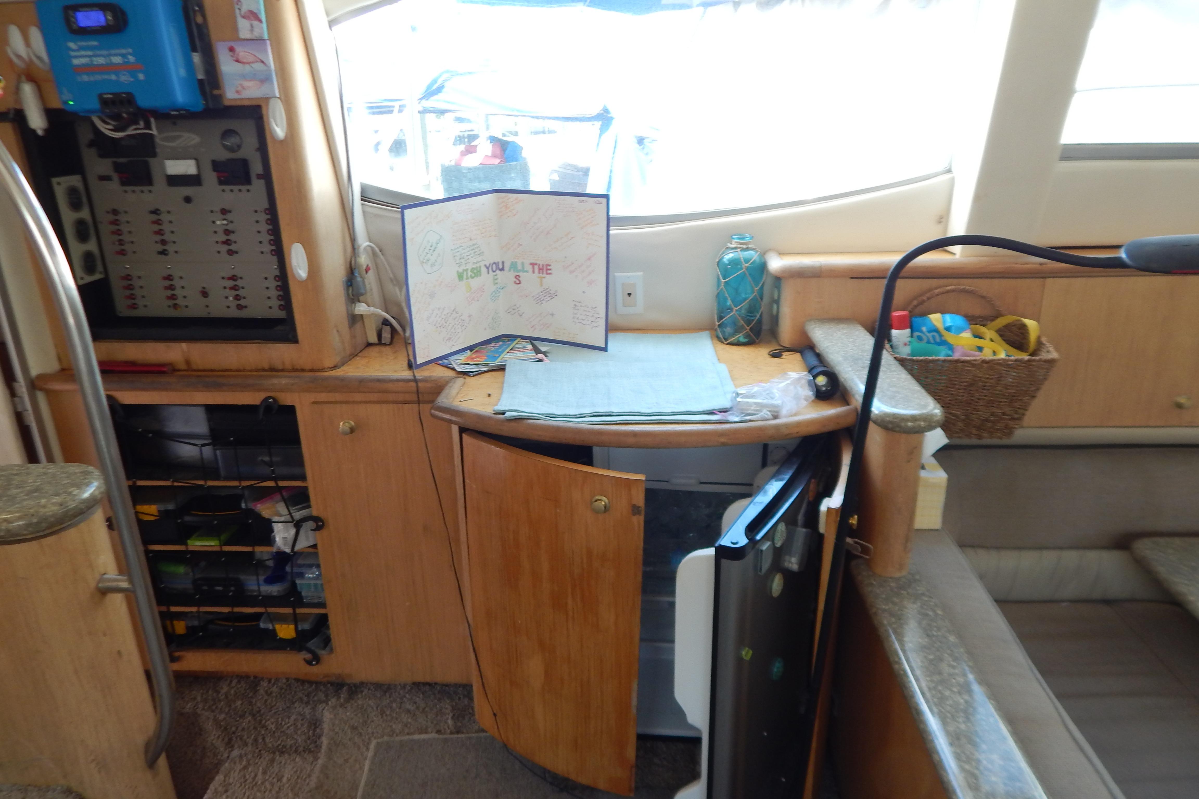Interior of a 1998 Magnum 4100 SCR yacht with control panel and open cabinet.