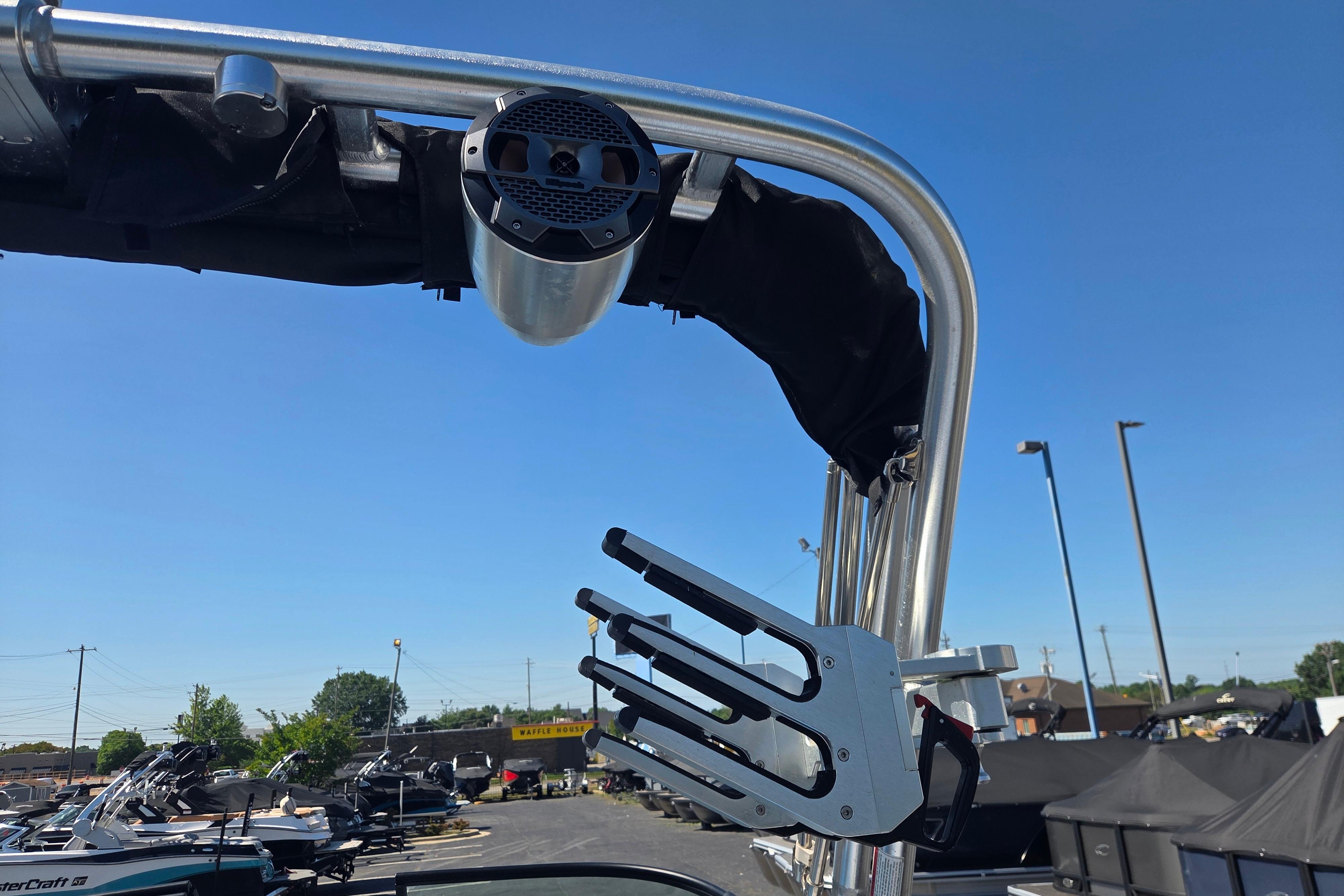 2022 MasterCraft NXT24 boat tower with speaker and wakeboard rack under clear blue sky.