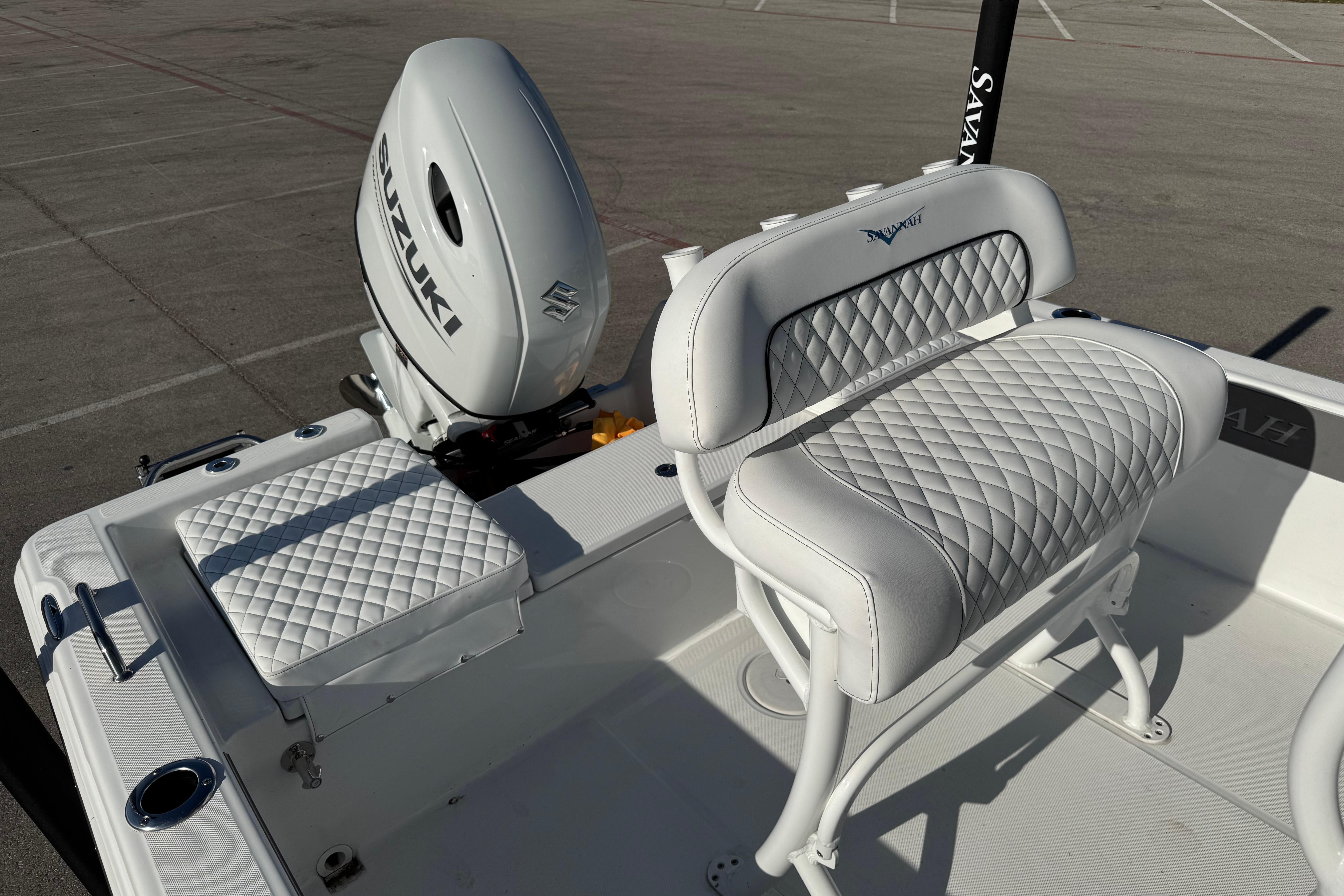2025 Savannah 210X boat interior with Suzuki engine and quilted seating.