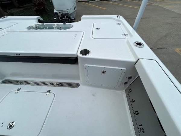 2024 Sea Pro 250 DLX boat deck with storage compartments and cup holders.