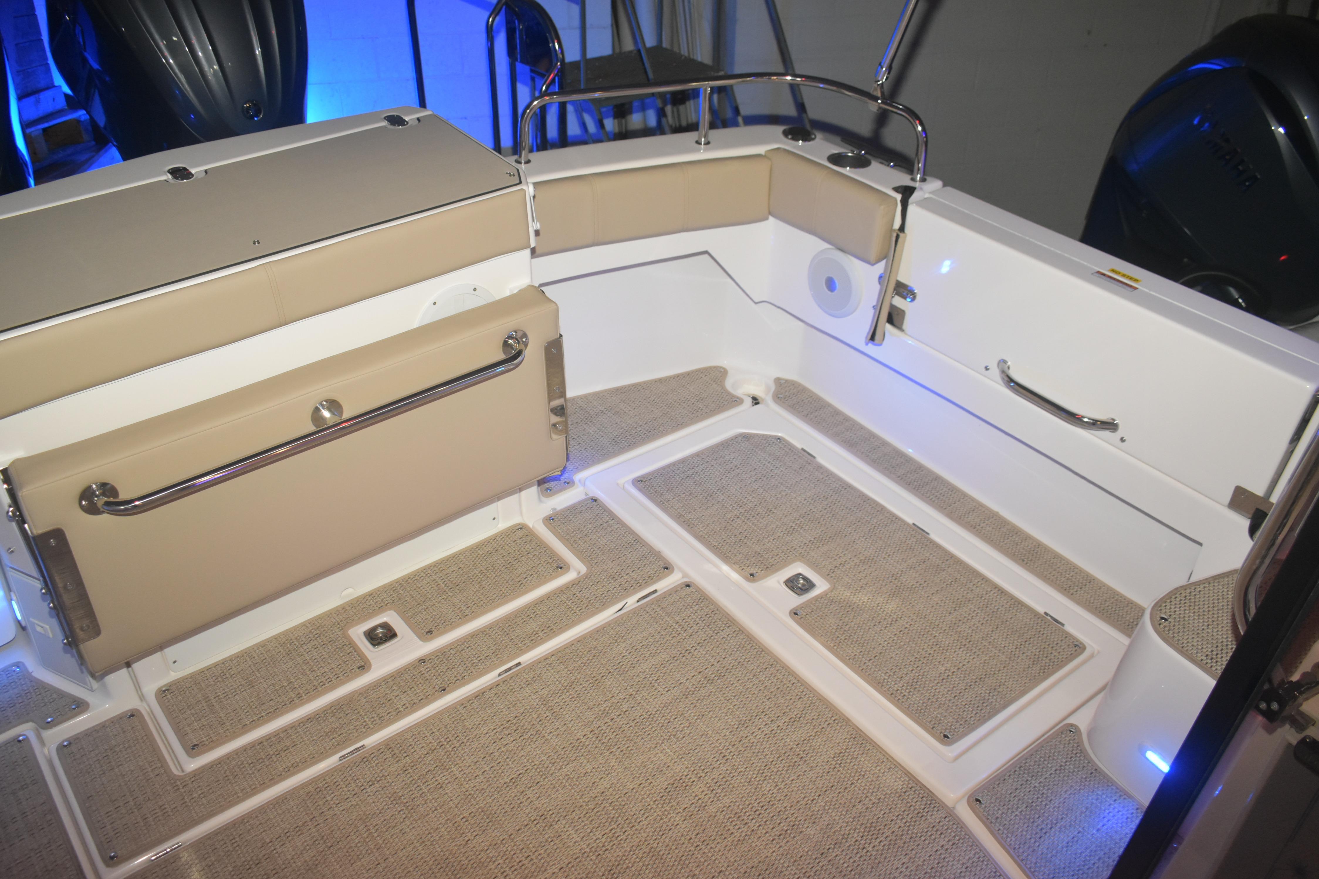 2026 Cutwater C-32 CB boat interior with beige seating and carpeted flooring.