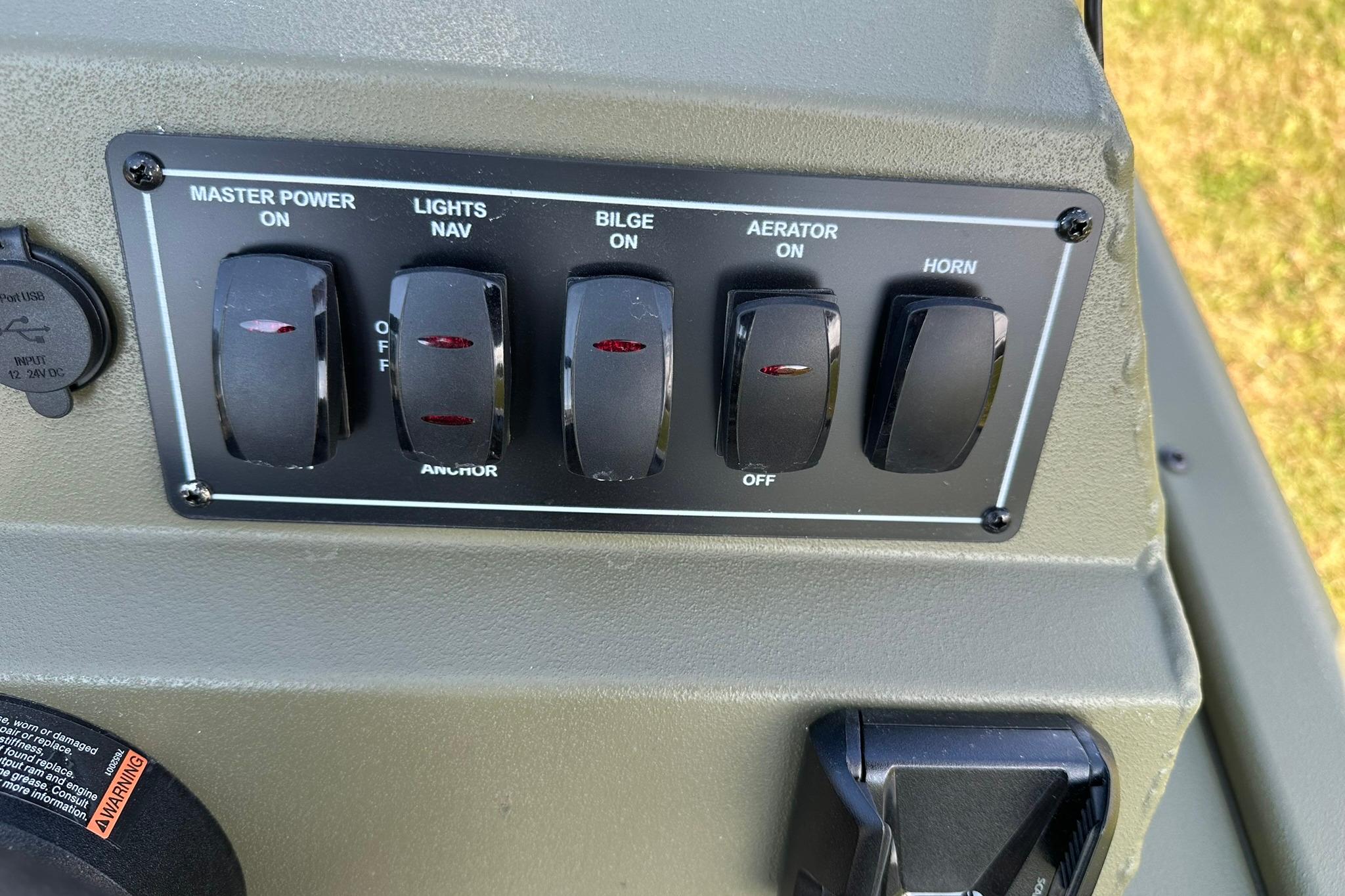 Control panel of 2026 Lowe Roughneck 1860SC boat with switches for power, lights, bilge, aerator, and horn.