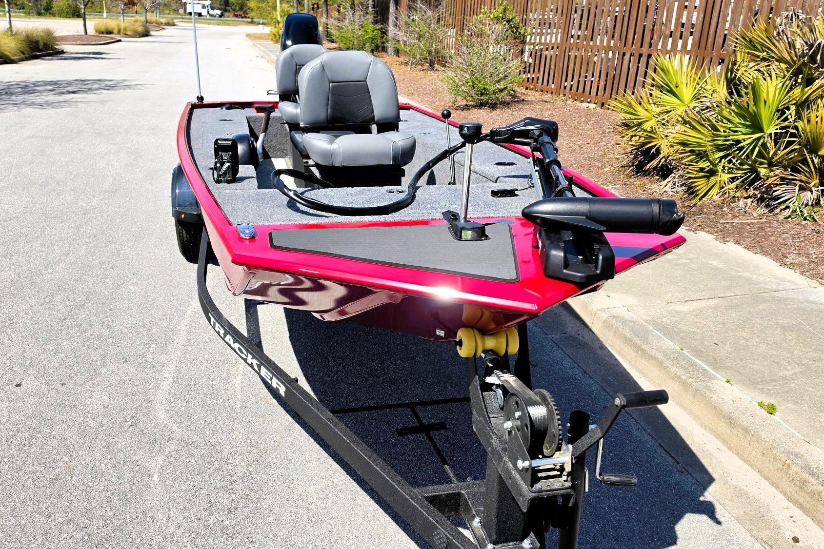 2026 Tracker Panfish 17 boat on trailer, red exterior, dual seats, parked on street.