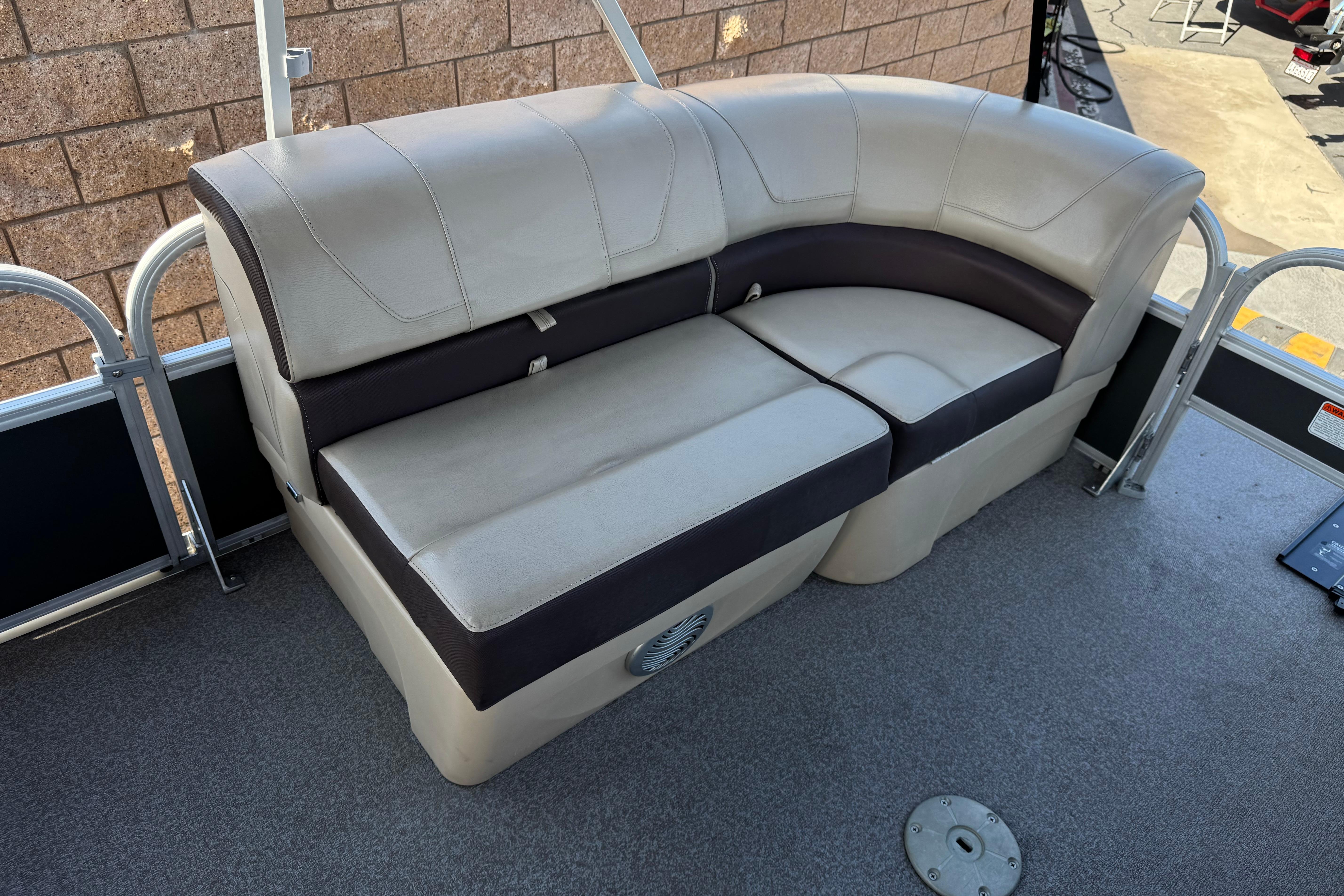 2018 Sun Tracker SportFish 22 DLX boat seating with beige and brown upholstery.