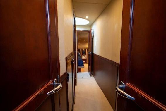 Hallway inside 2006 Sea Ray 580 Sedan Bridge yacht with wooden doors and elegant design.