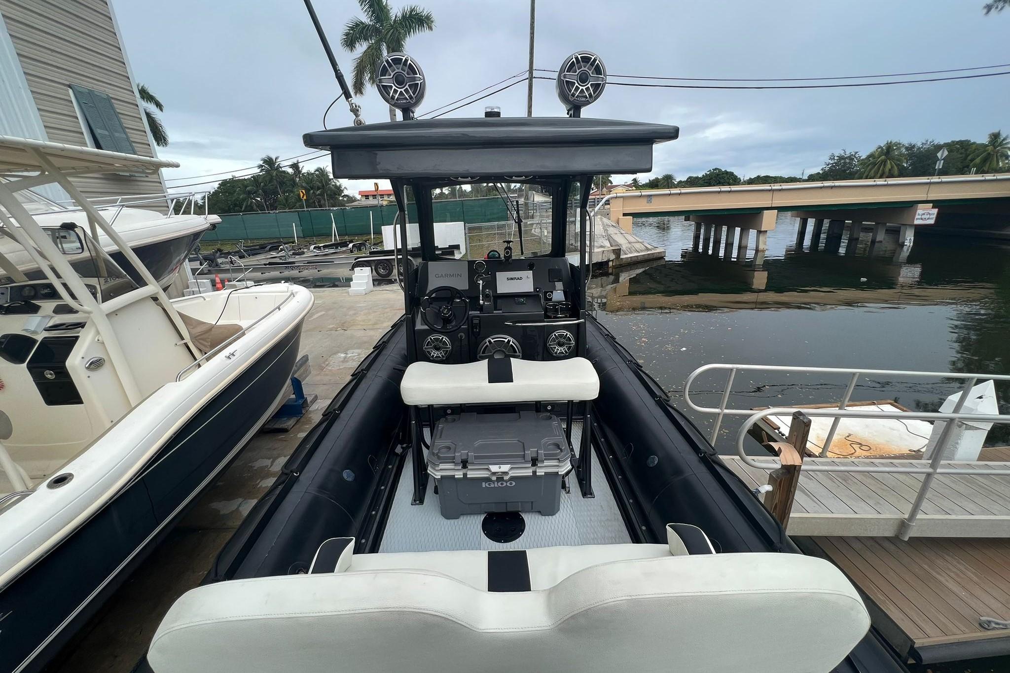 Zodiac Milpro Hurricane Custom 2014 boat docked, featuring advanced navigation equipment and seating.