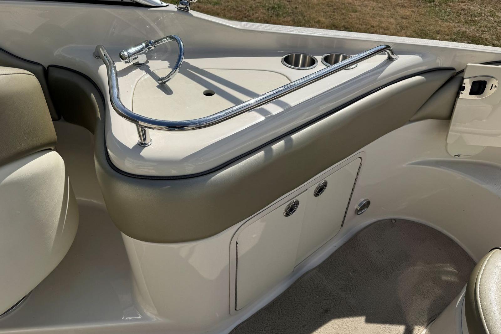 2006 Sea Ray 240 Sundeck interior with sink and cup holders.
