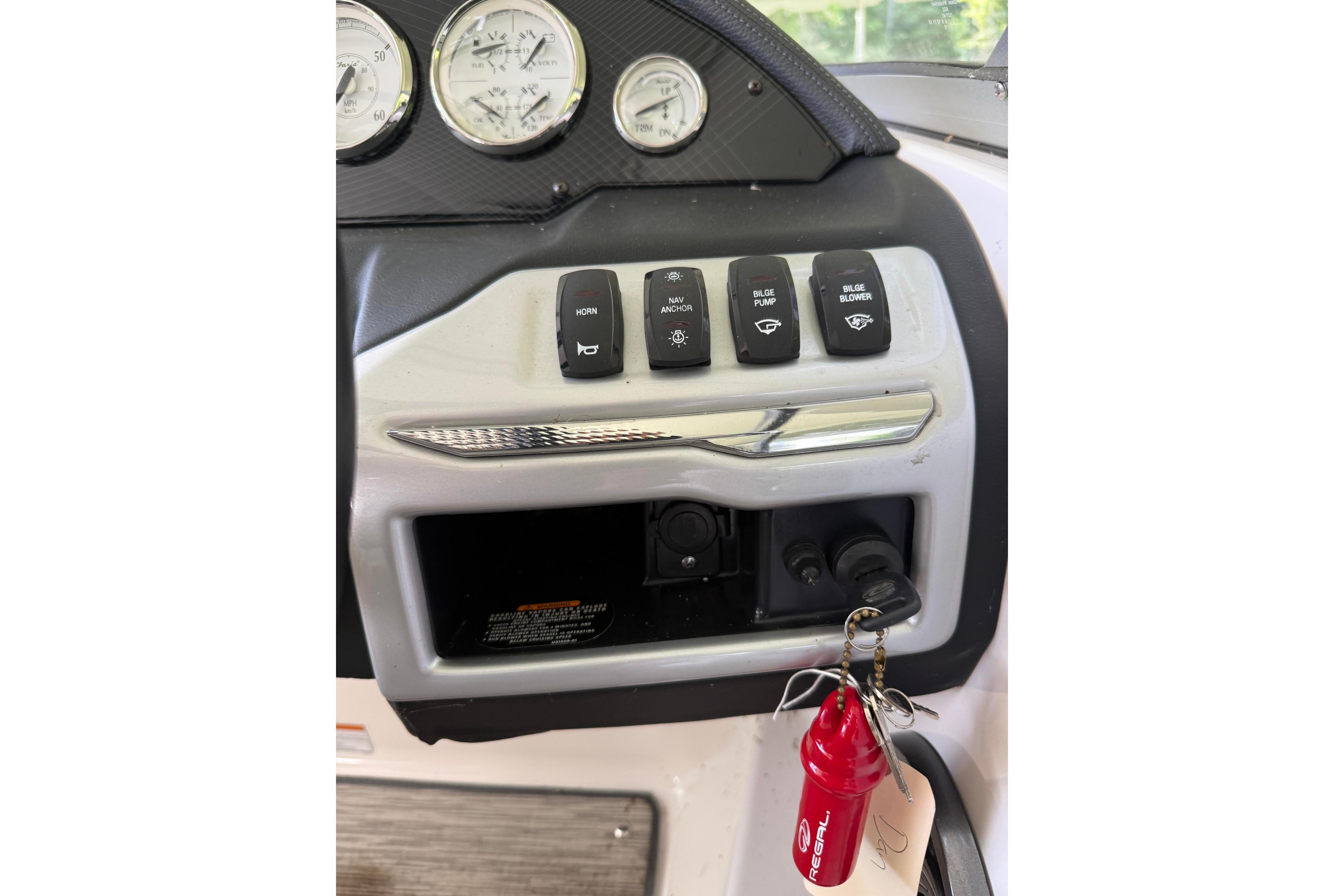 Dashboard controls of a 2016 Regal 1900 ES Bowrider boat with keychain.