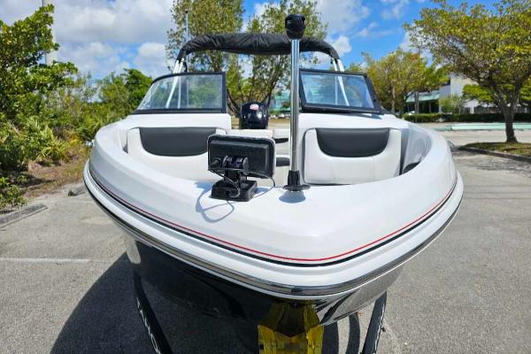 2025 Tahoe 185 S boat, sleek design, parked outdoors under a clear blue sky.