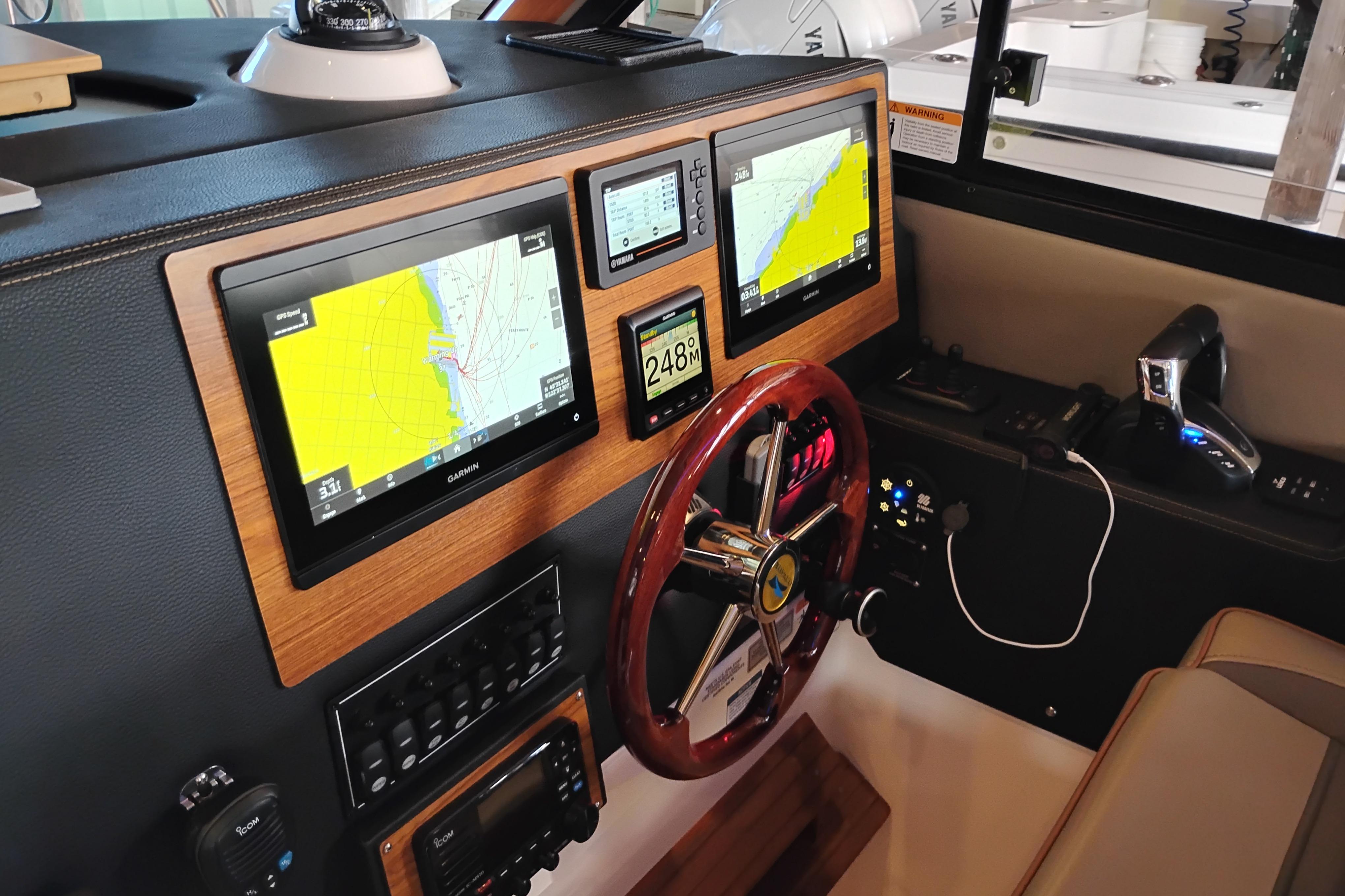 2022 Cutwater C-32 Coupe helm with navigation screens and controls.