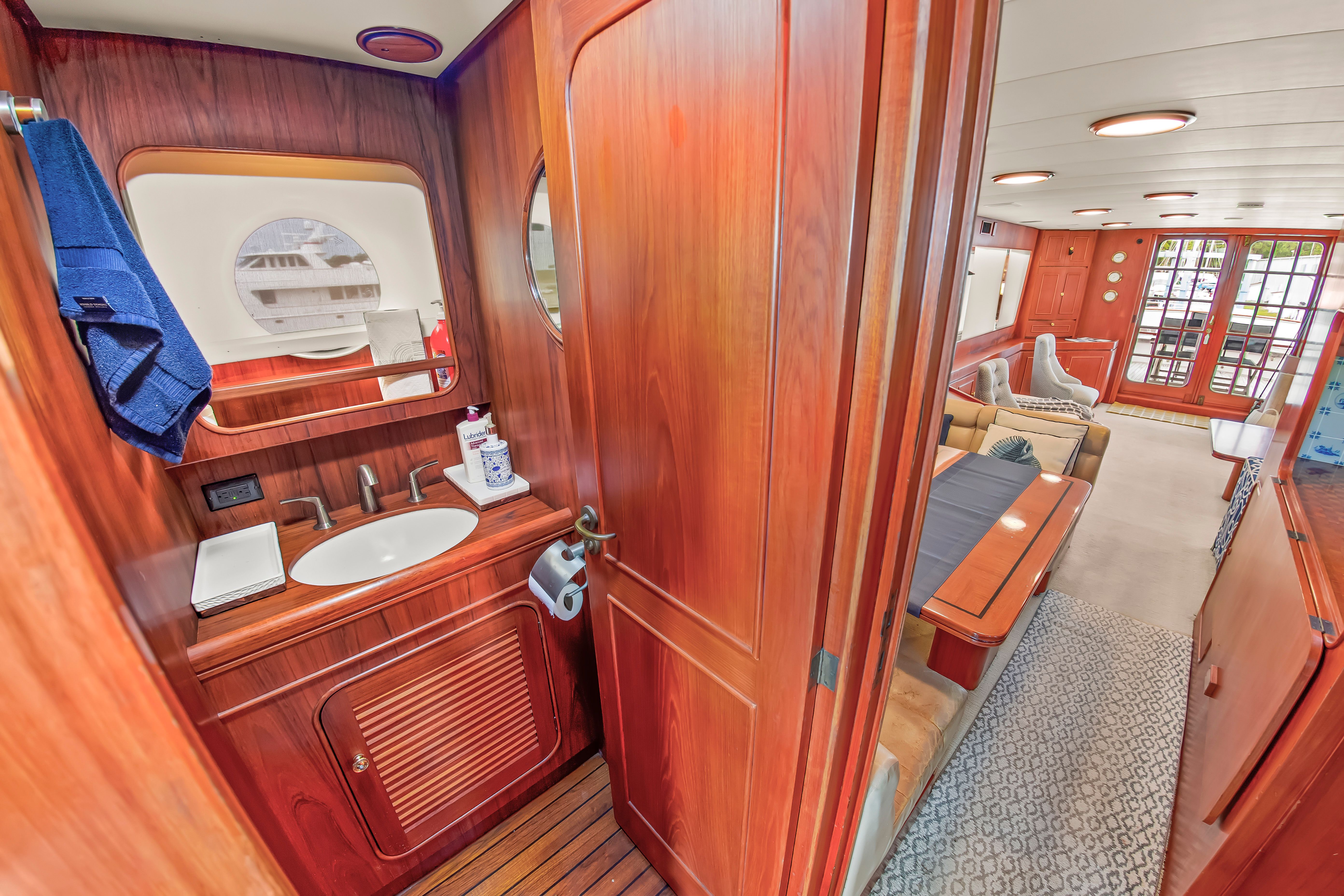 Interior of a 1987 Jongert 78 Motor Yacht with wood finishes and a cozy living area.