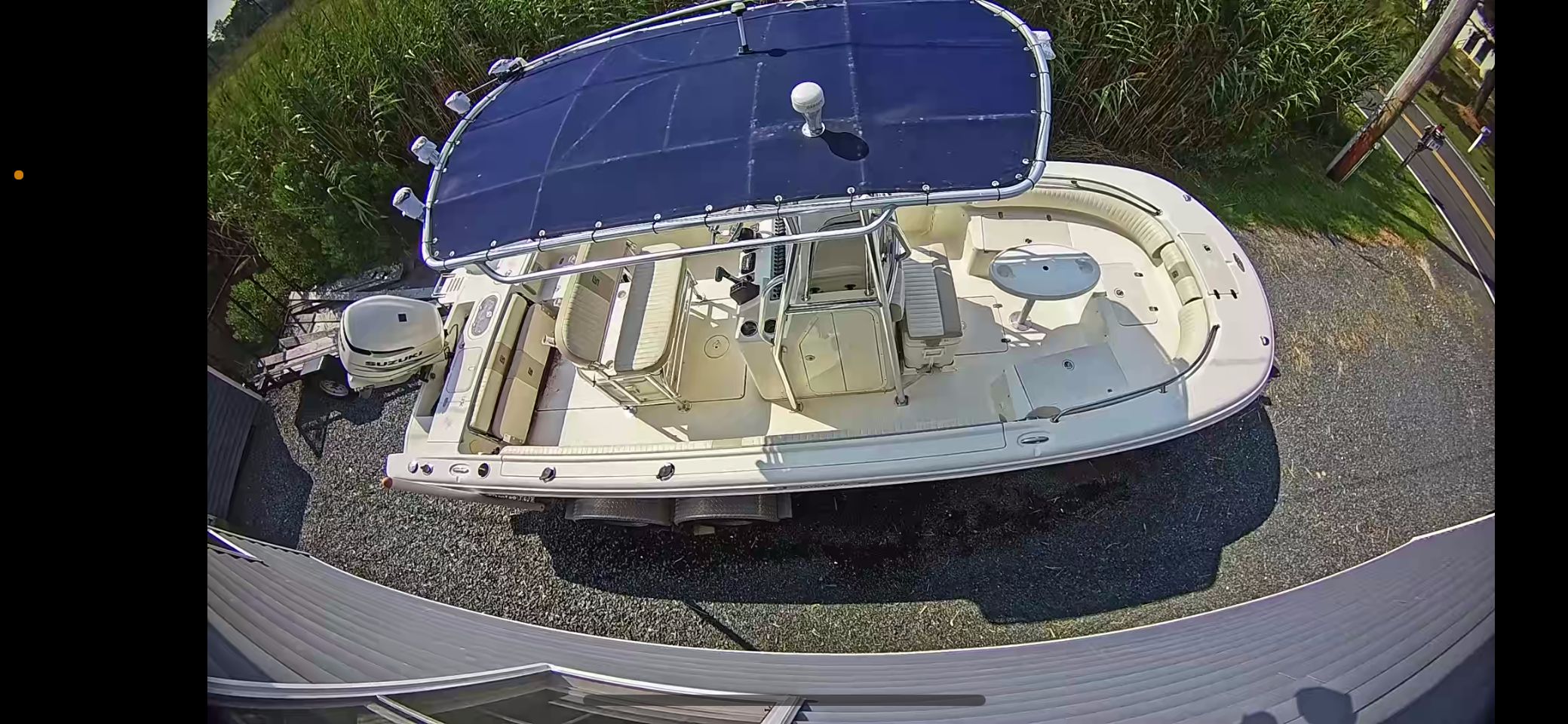 2014 Carolina Skiff 23 Ultra Elite boat parked on gravel surface.