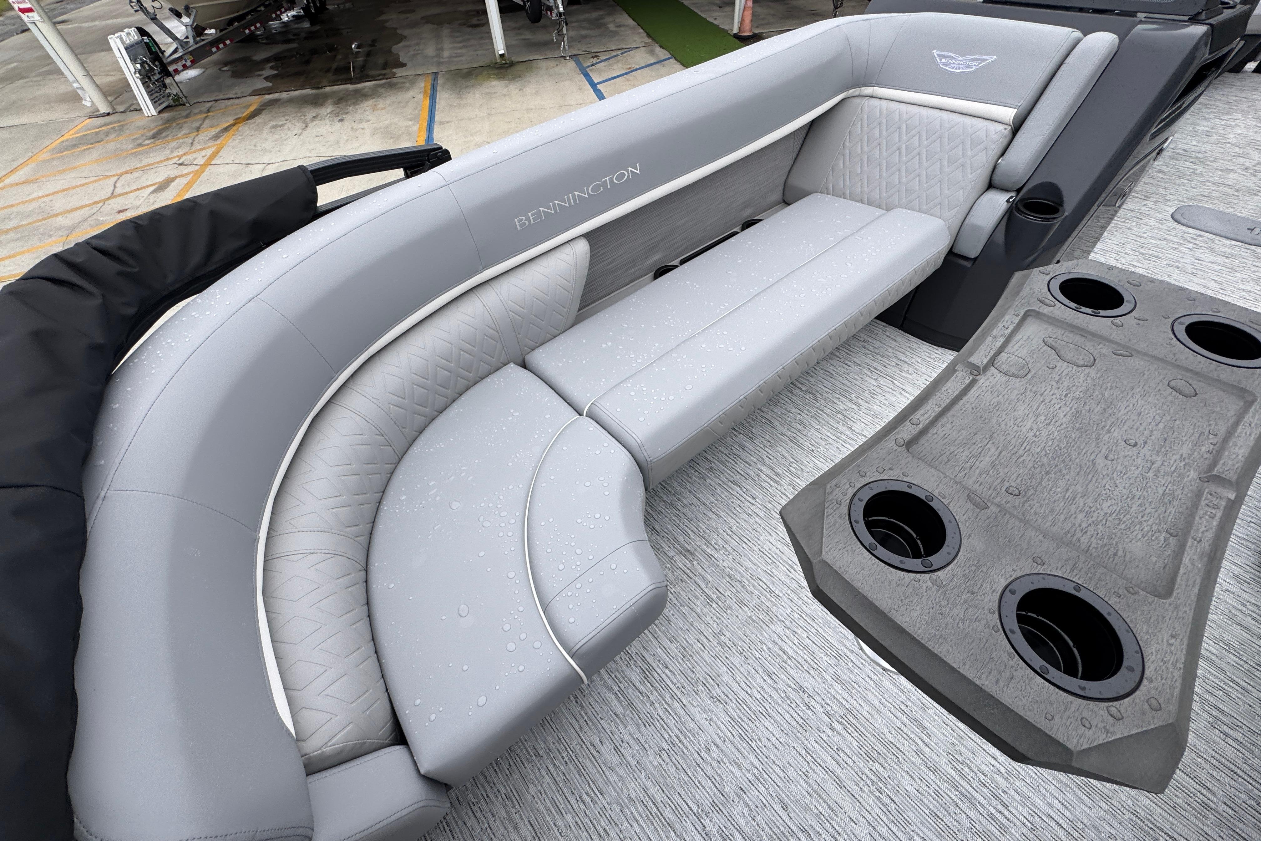 Luxurious seating on a 2027 Bennington 24 MFB pontoon boat with sleek gray upholstery.
