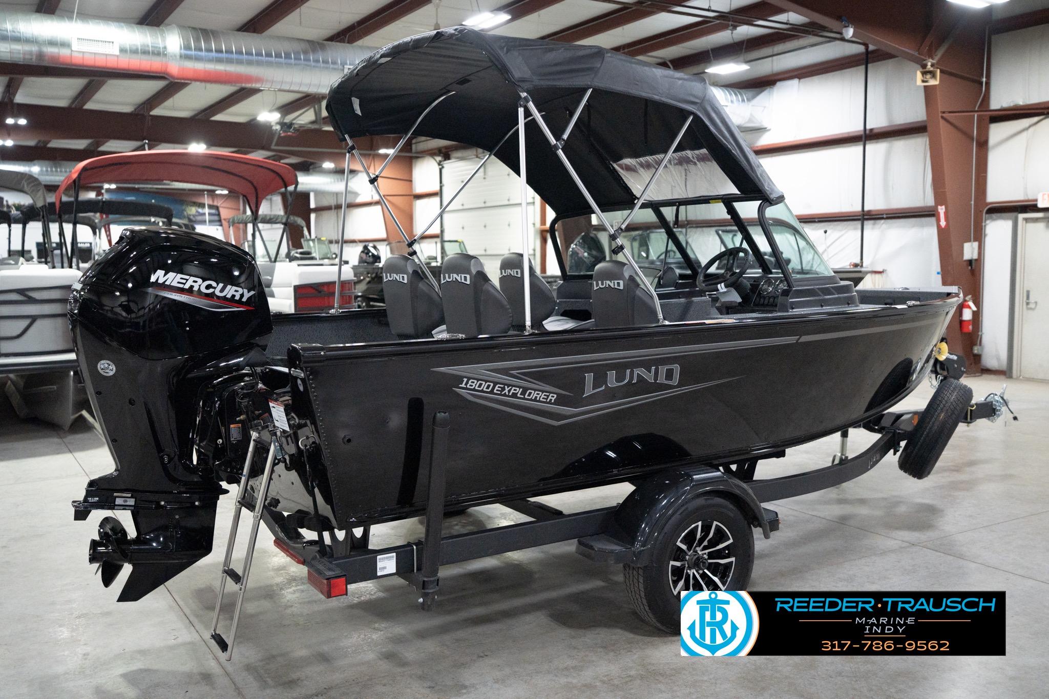 2026 Lund 1800 Explorer Sport boat with Mercury engine in showroom.