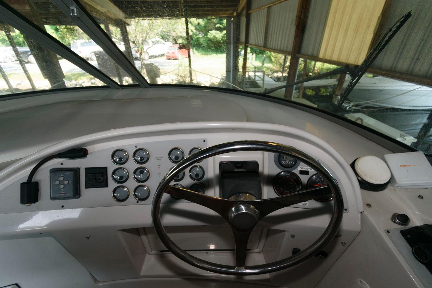 1997 Bluewater Yachts 680 Custom Series helm with steering wheel and control panel.