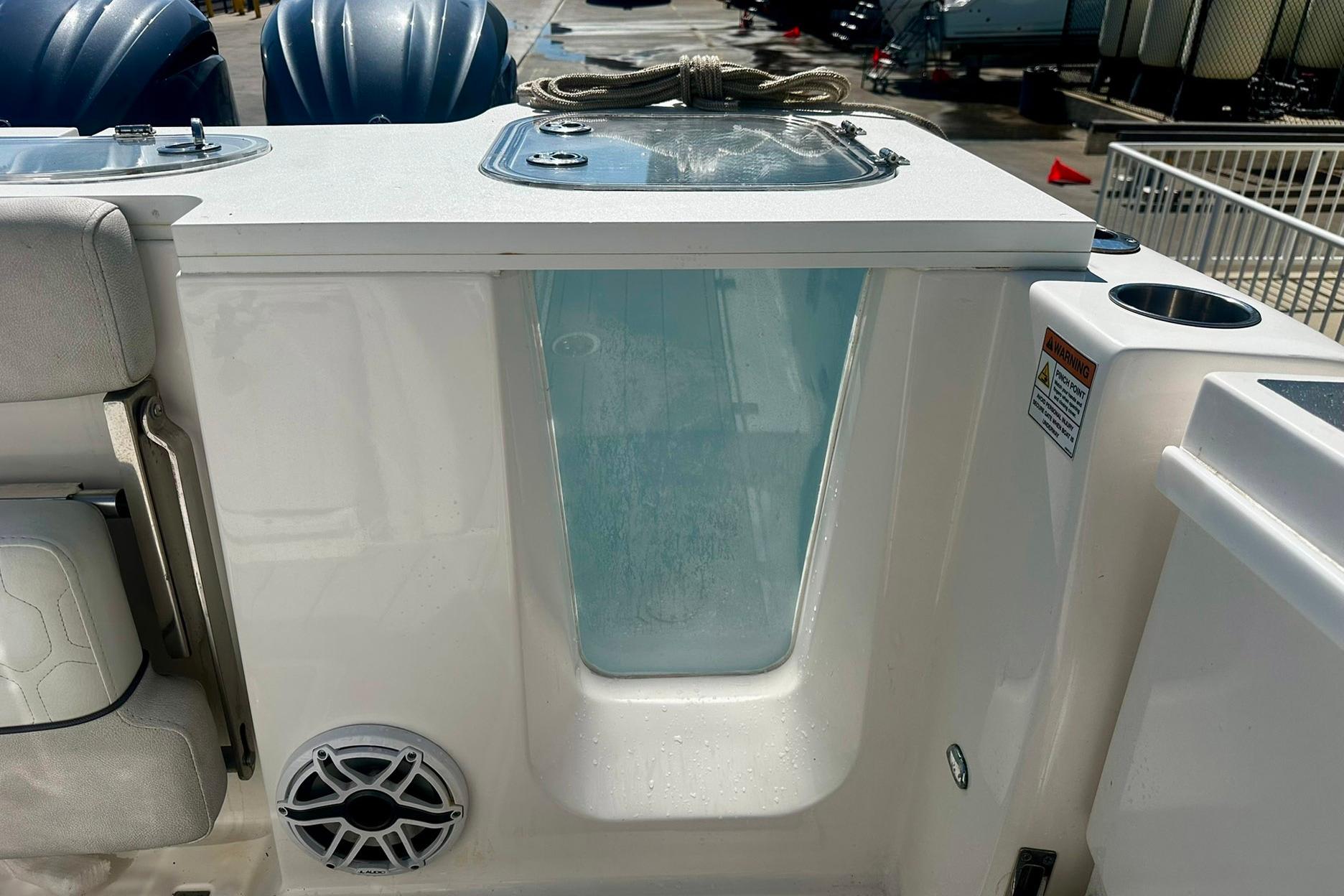 Sea Fox 228 Commander 2002 boat interior with livewell and speaker.