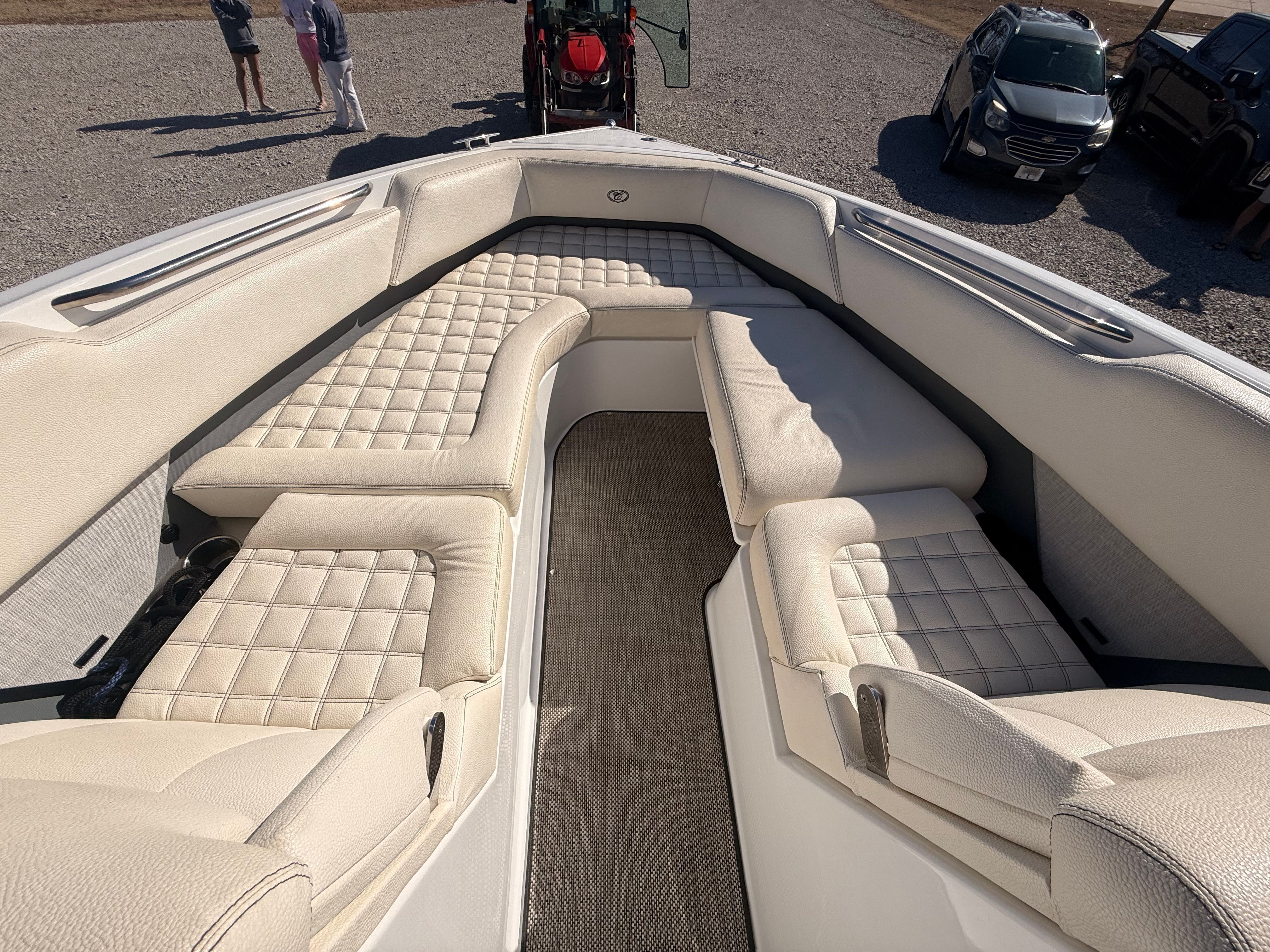 The image shows the bow area of a 2019 Cobalt R7 Surf boat with beige upholstery.
