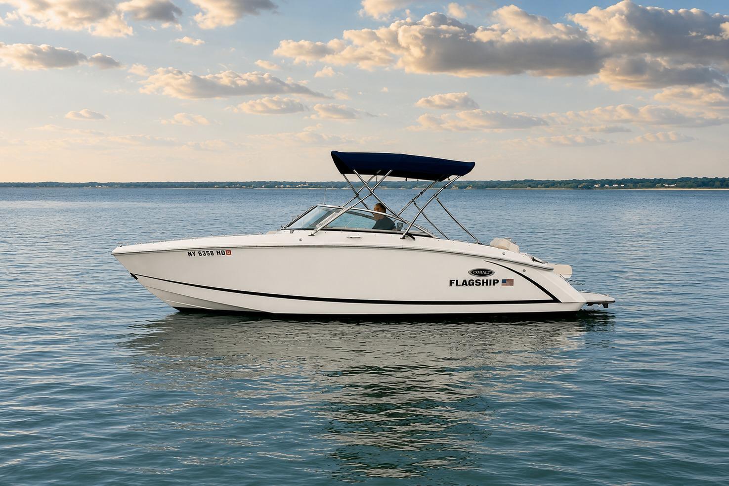 2019 Cobalt R3 boat on calm water under a partly cloudy sky.