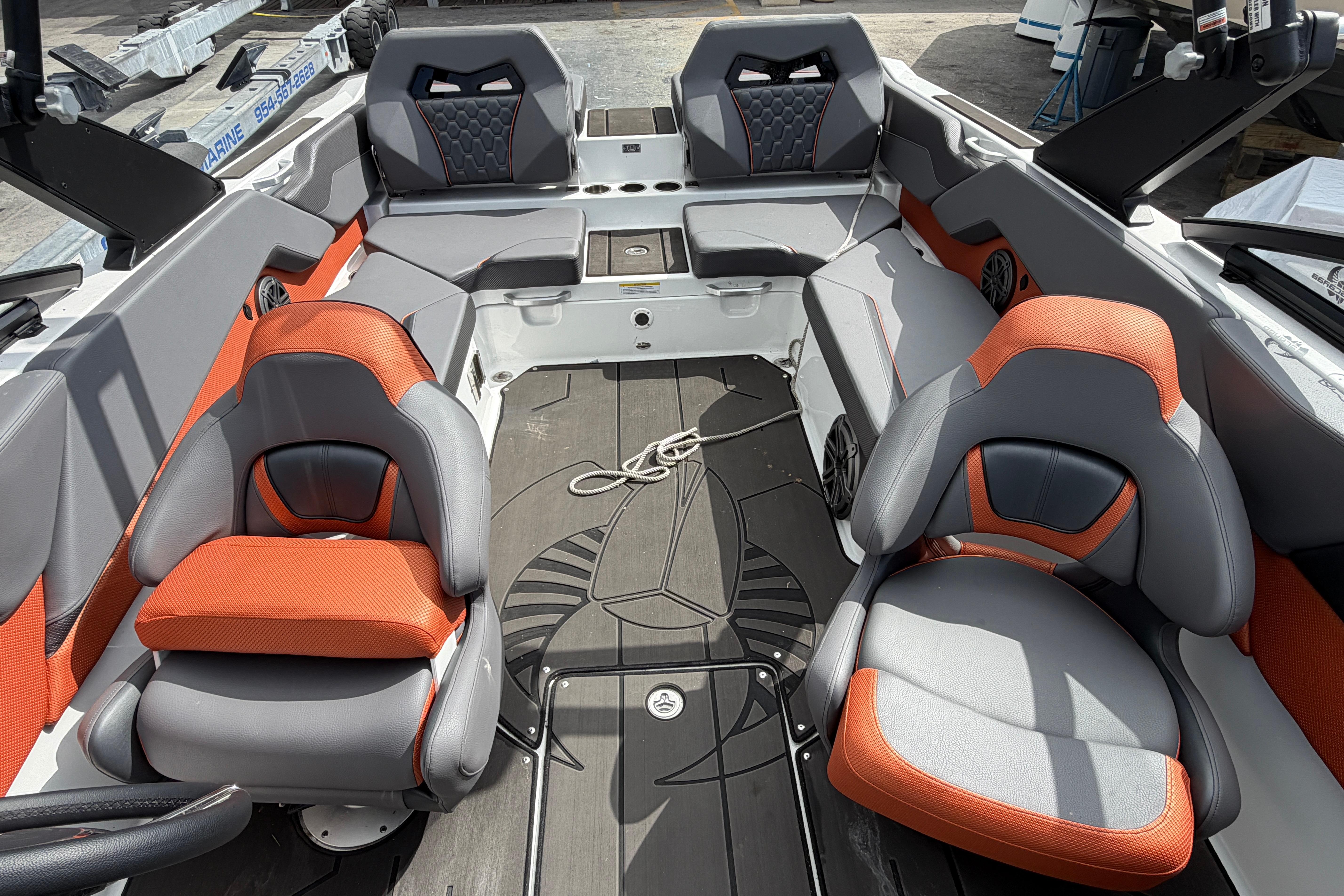 2026 Scarab 235 LX boat interior with orange and gray seating, modern design.