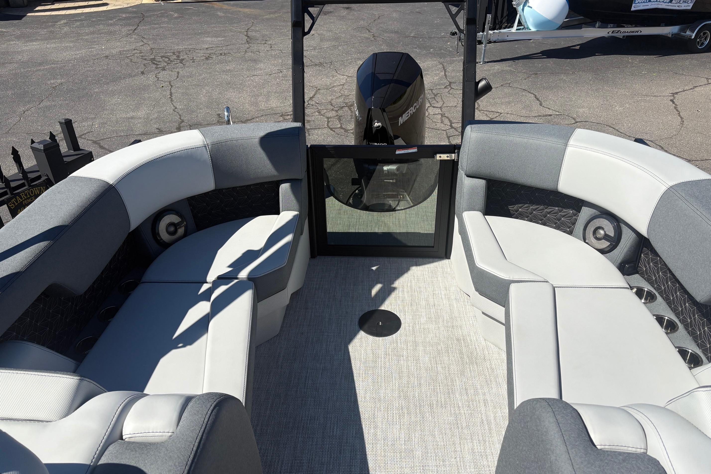 2026 Alera 23Q boat interior with gray seating and Mercury engine.