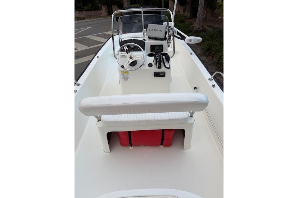 2016 Boston Whaler 150 Montauk boat interior with steering console and seating.