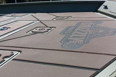 2026 Tracker Grizzly 2072 CC boat deck with logo and storage compartments.