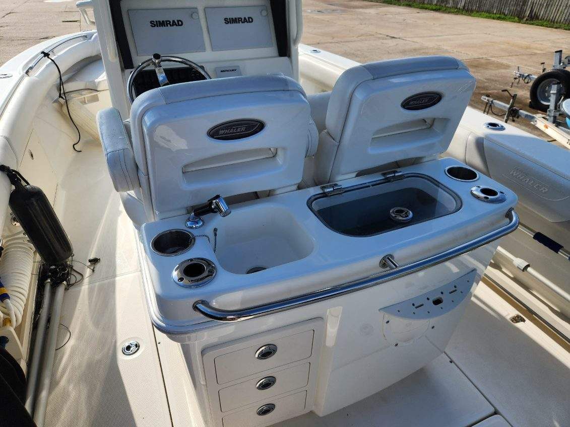 2016 Boston Whaler 250 Outrage with helm console and seating area.