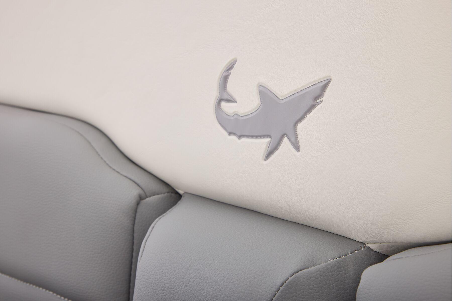 Gray shark logo on Mako 24 APEX 2026 boat seat upholstery.
