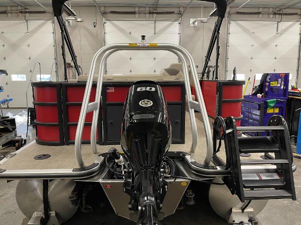 2025 Bentley Pontoons 200 Fish-N-Cruise with outboard motor in a garage setting.